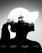 Double exposure of woman's silhouette and monument
