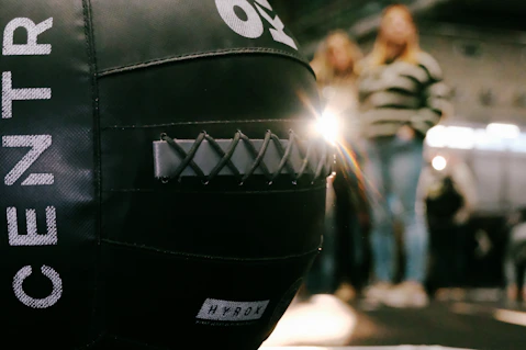 Black medicine ball with people in background