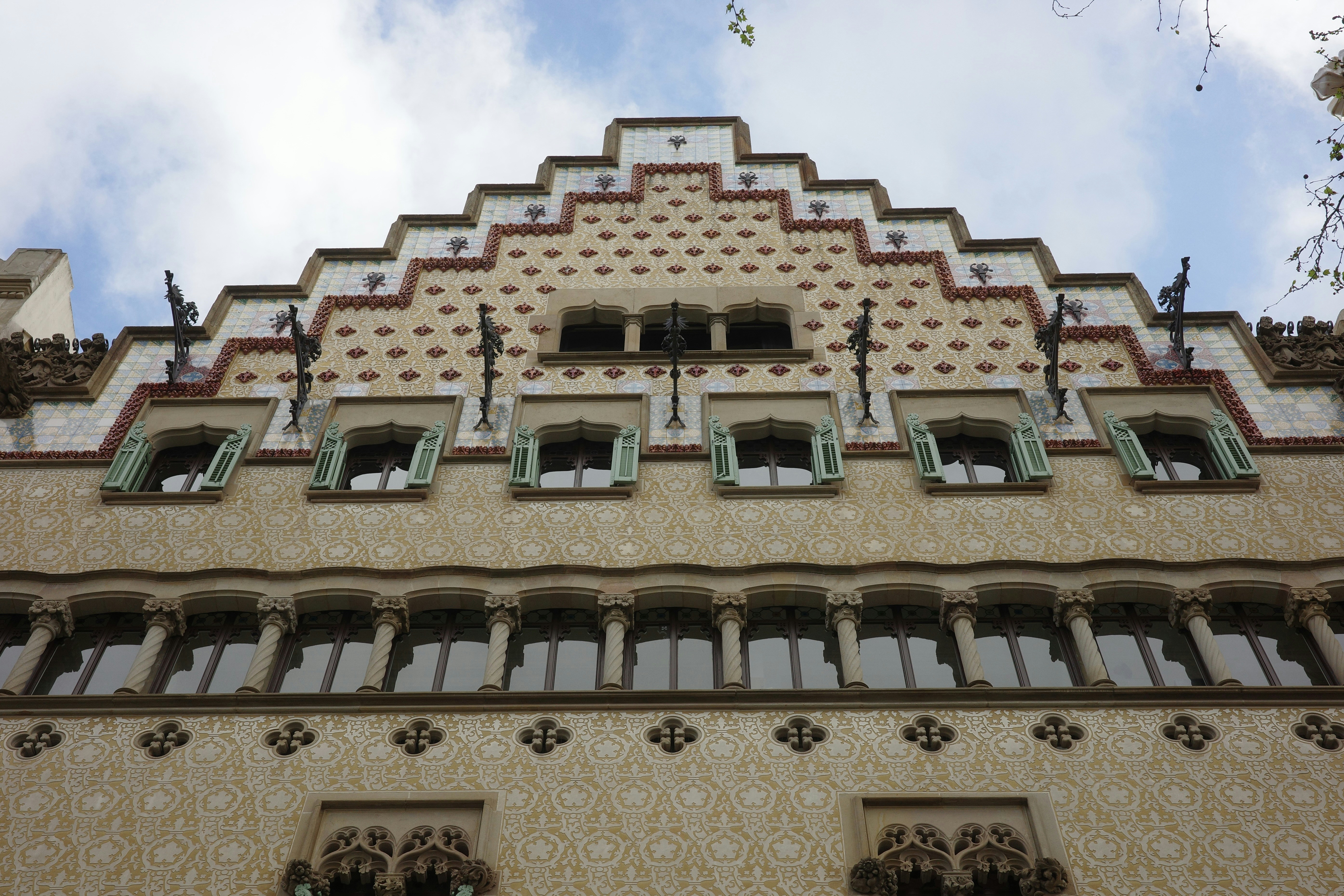 Ornate building facade with patterned windows and decorative roof