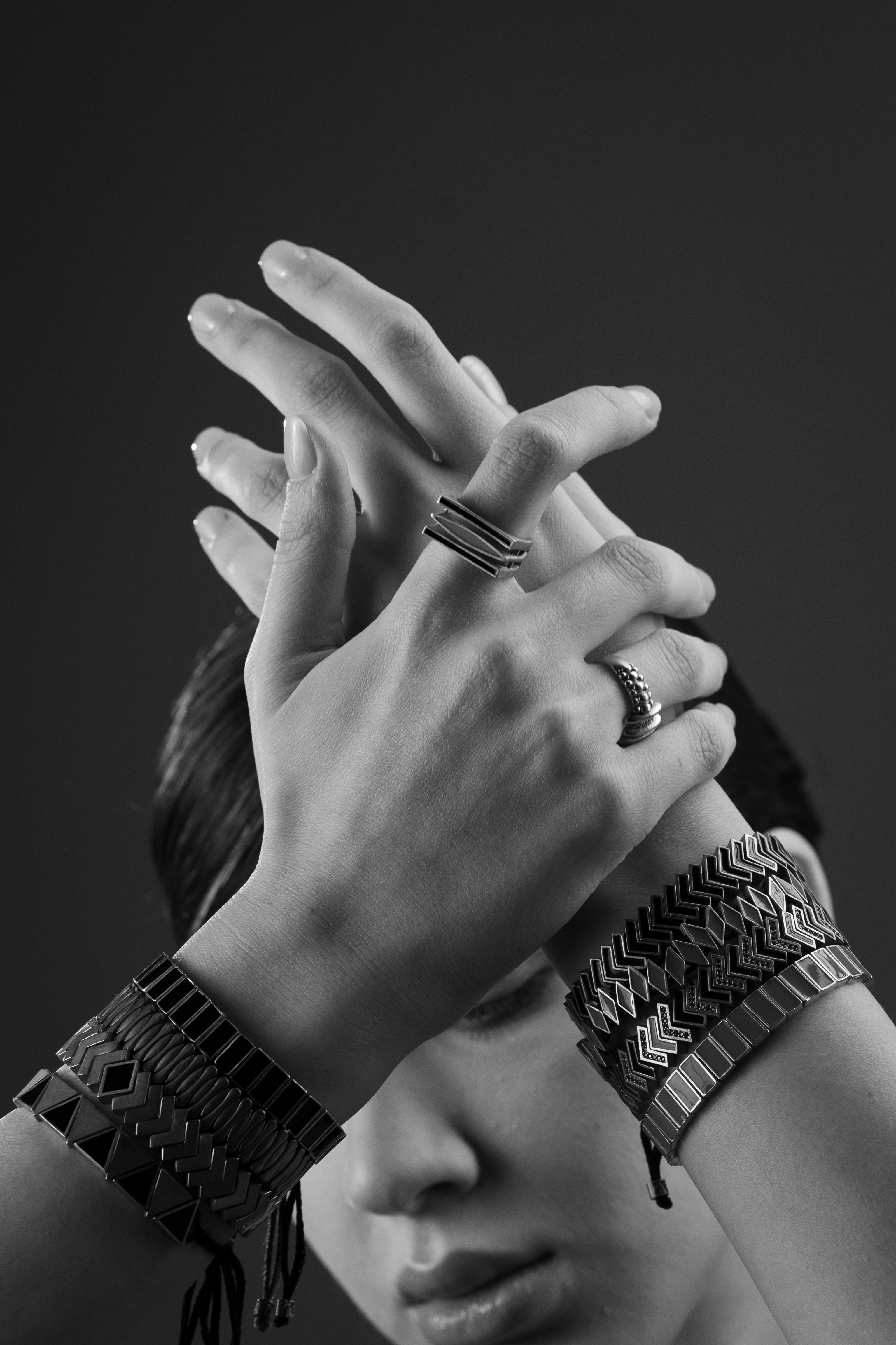 Woman's hands adorned with rings and bracelets