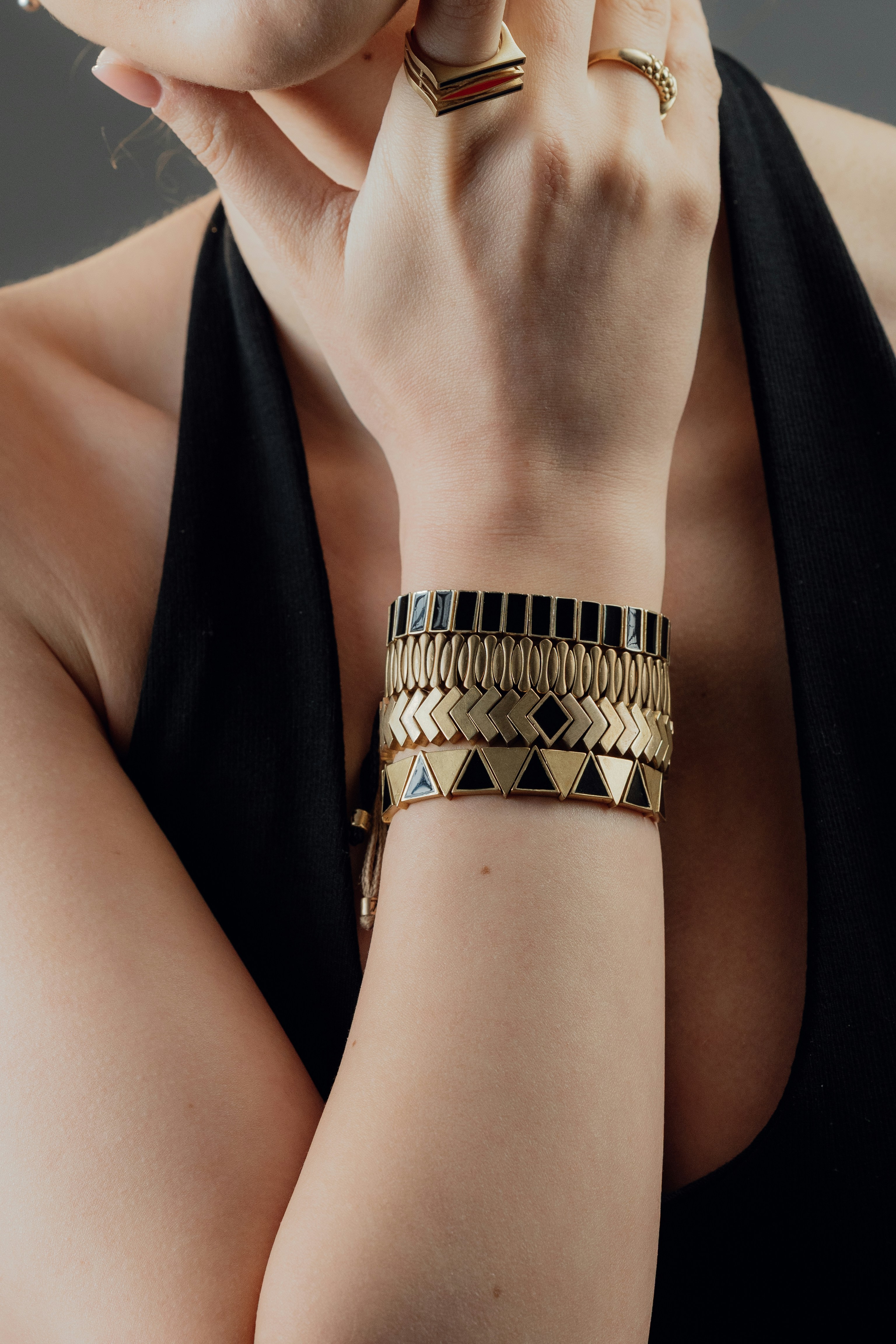 Woman wearing stacked bracelets and rings