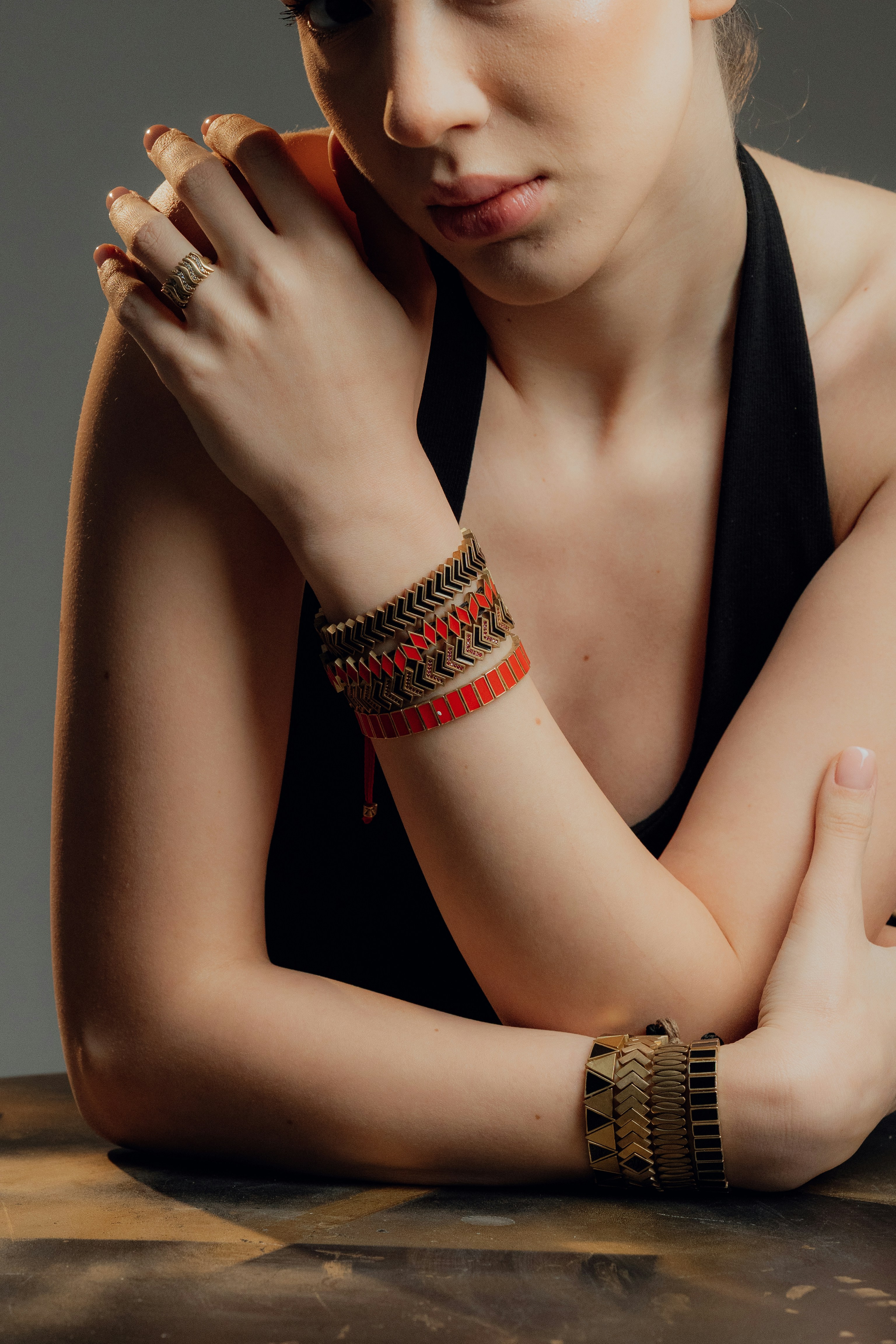 Woman wearing stacked bracelets and ring