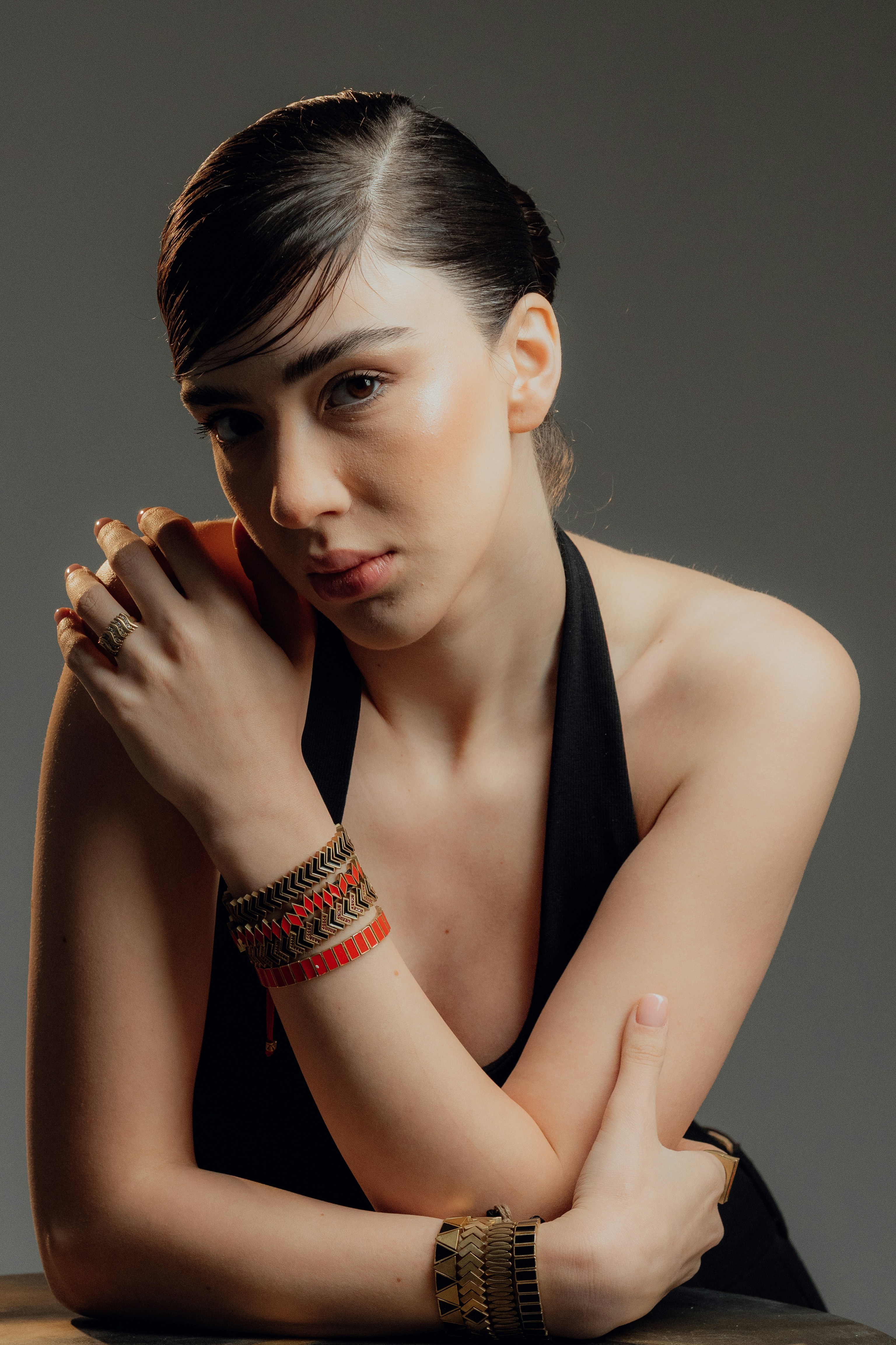 A young woman with bracelets and dark hair