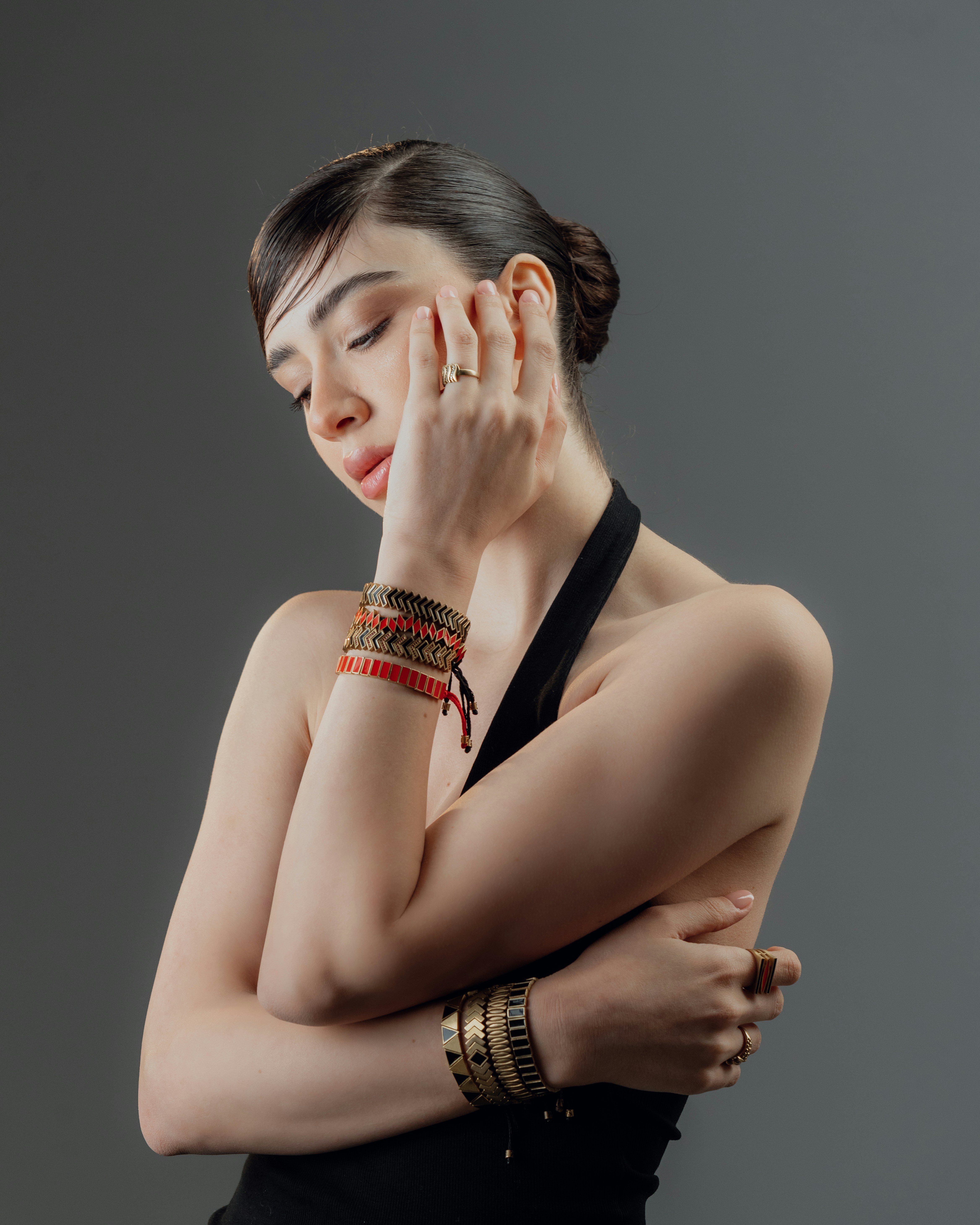 Woman with bracelets touching her face