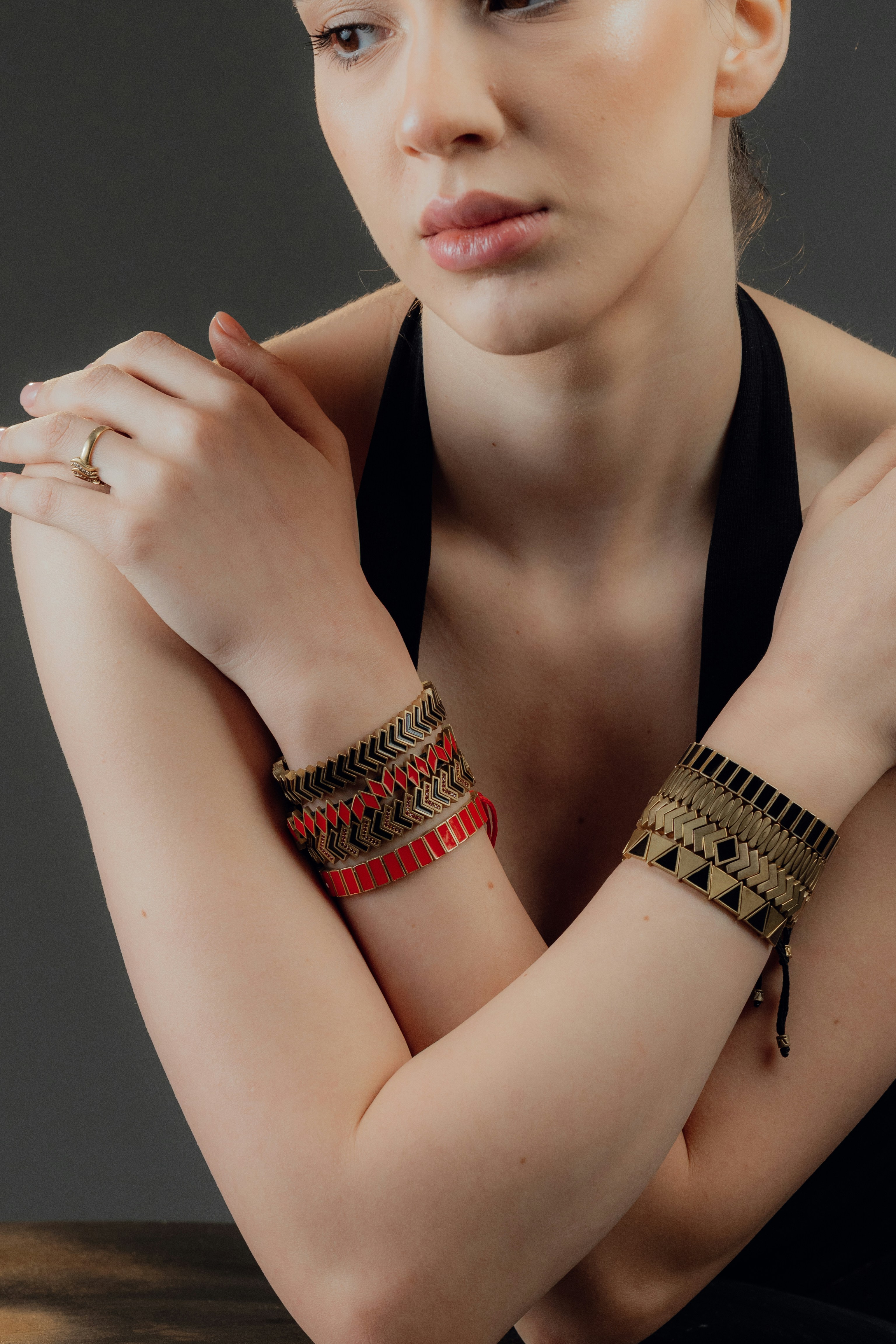 Woman wearing two patterned bracelets on arms