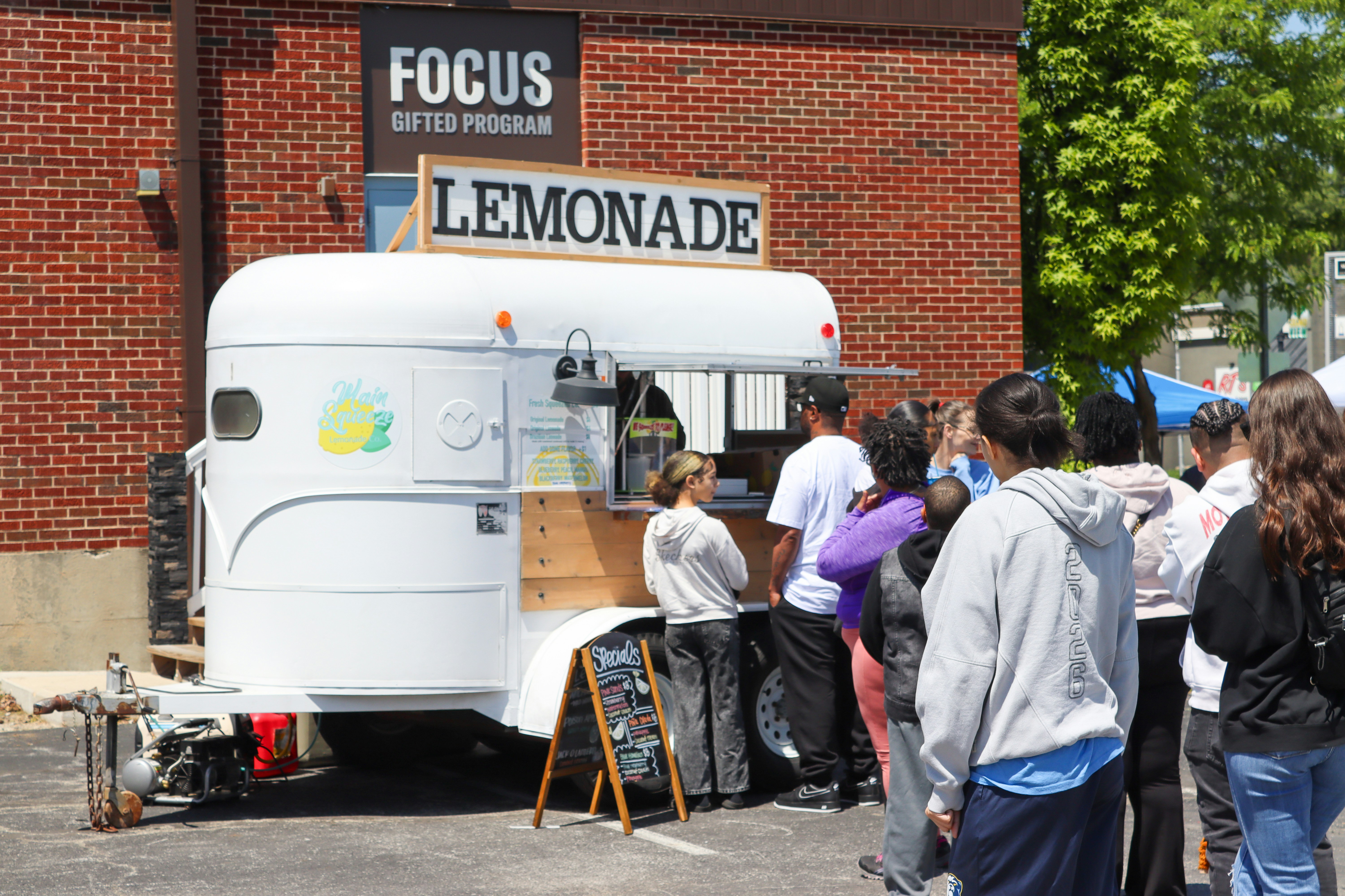 Lemonade trailer with people waiting to purchase.