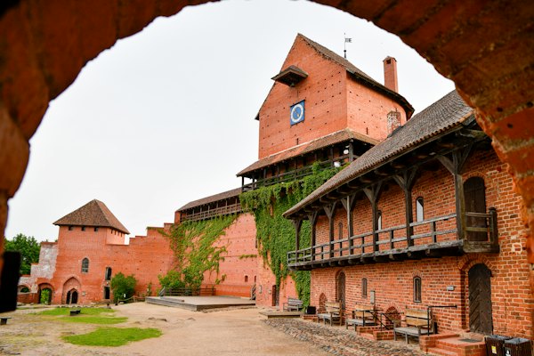 Medieval brick castle courtyard with wooden balconies — Sigulda, Latvia