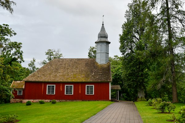 A red wooden church with a tall steeple — Sigulda, Latvia