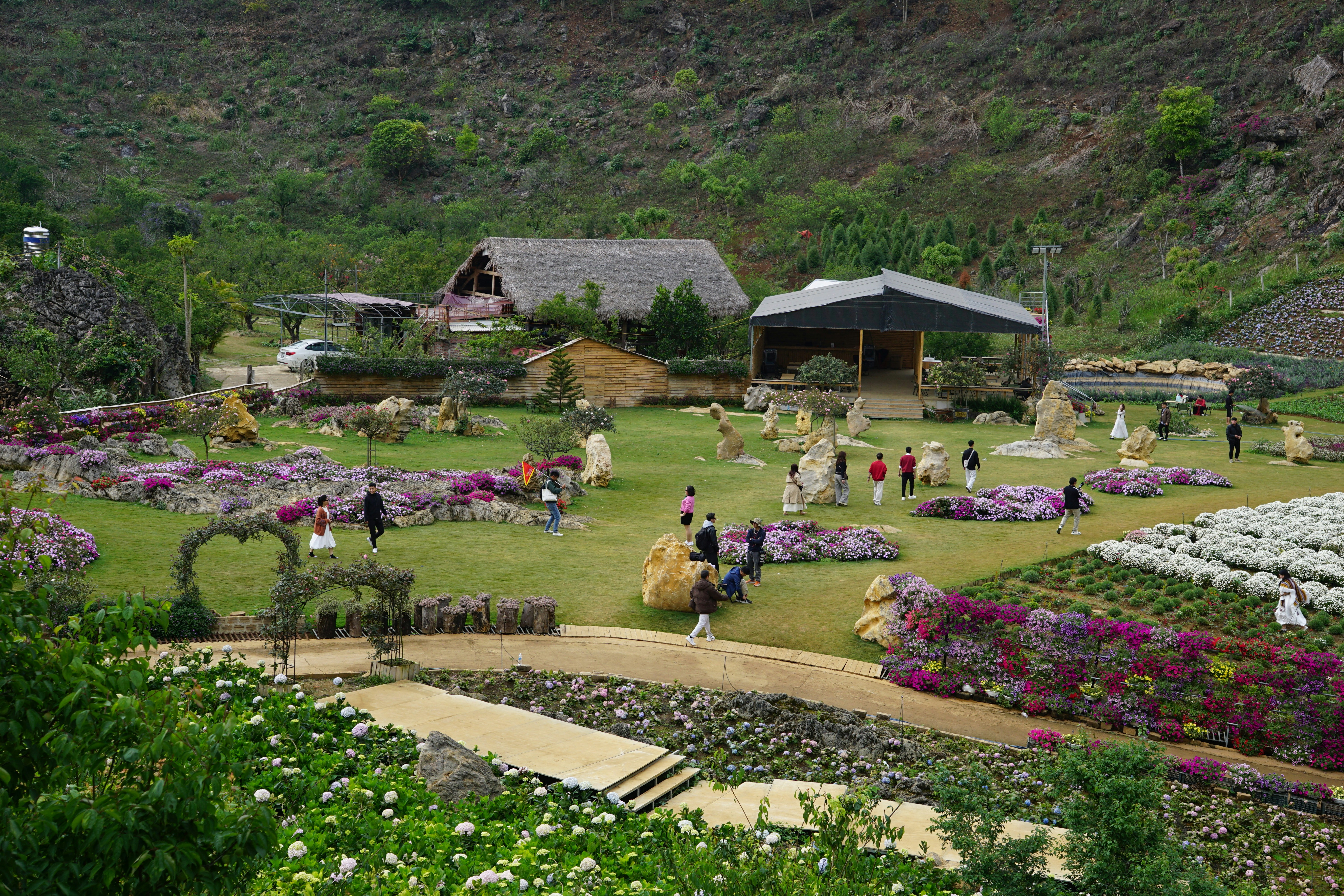 Lush garden with blooming flowers and people strolling
