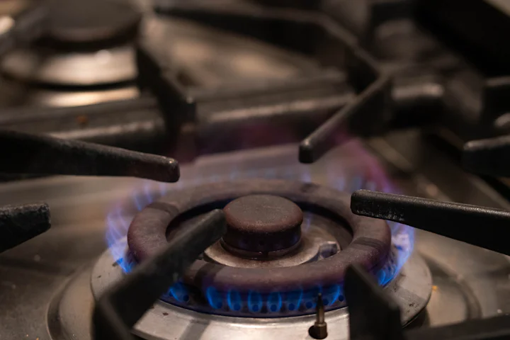 A gas stove burner with blue flames