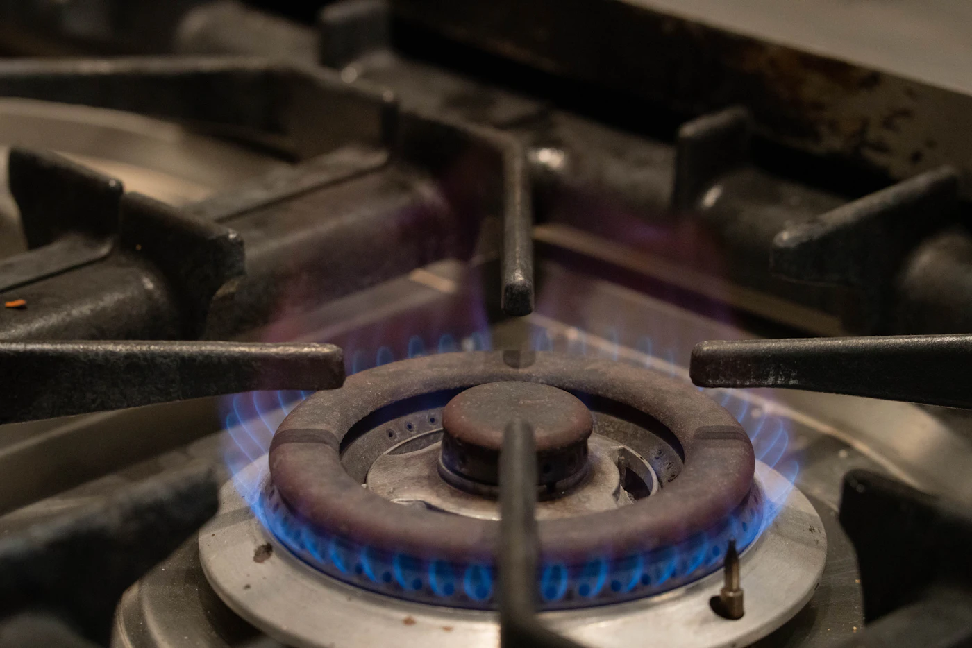 Lit gas hob burner viewed close up