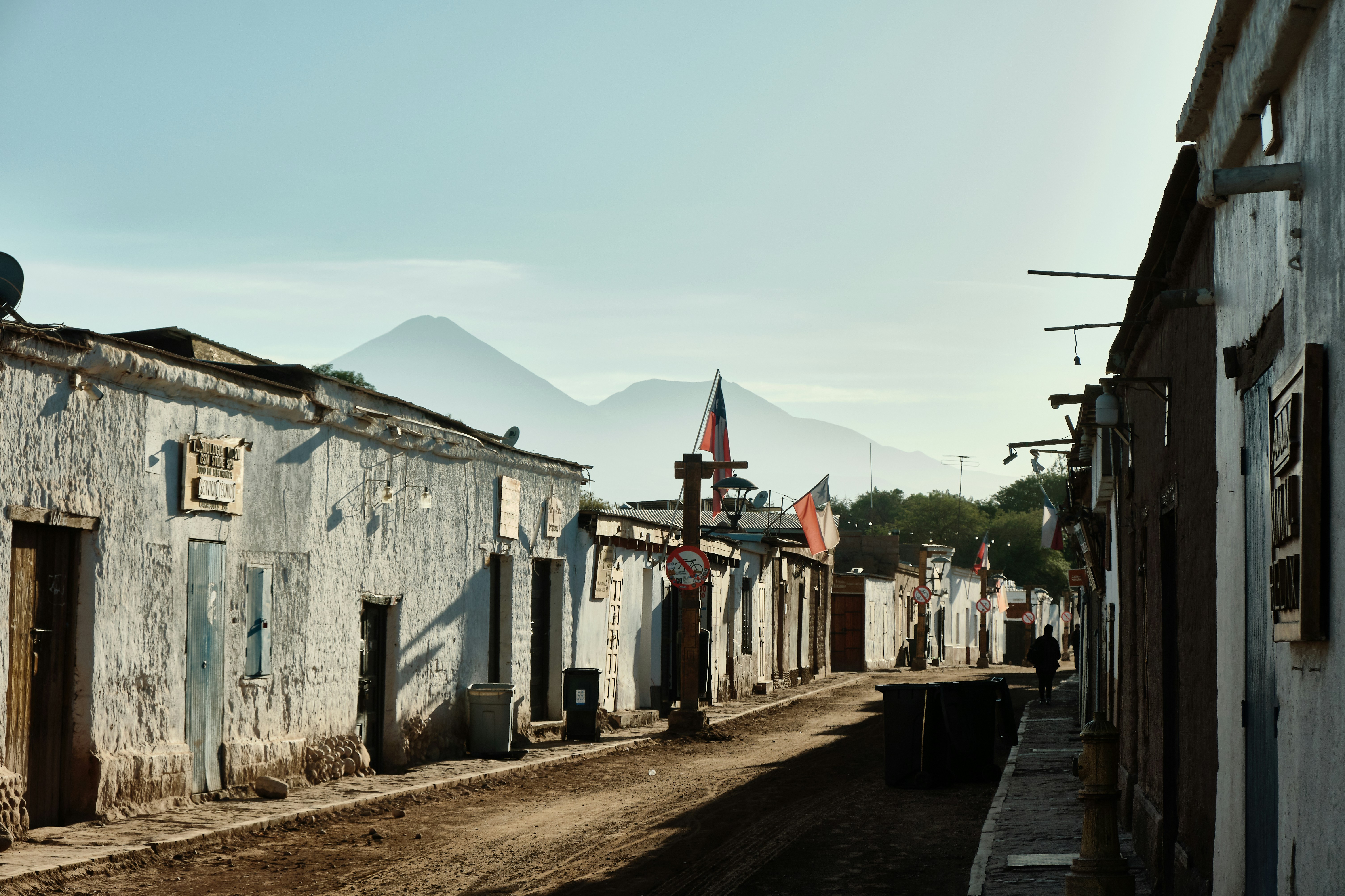 Latin America technology startup city - A dusty street in a small town with mountains beyond.