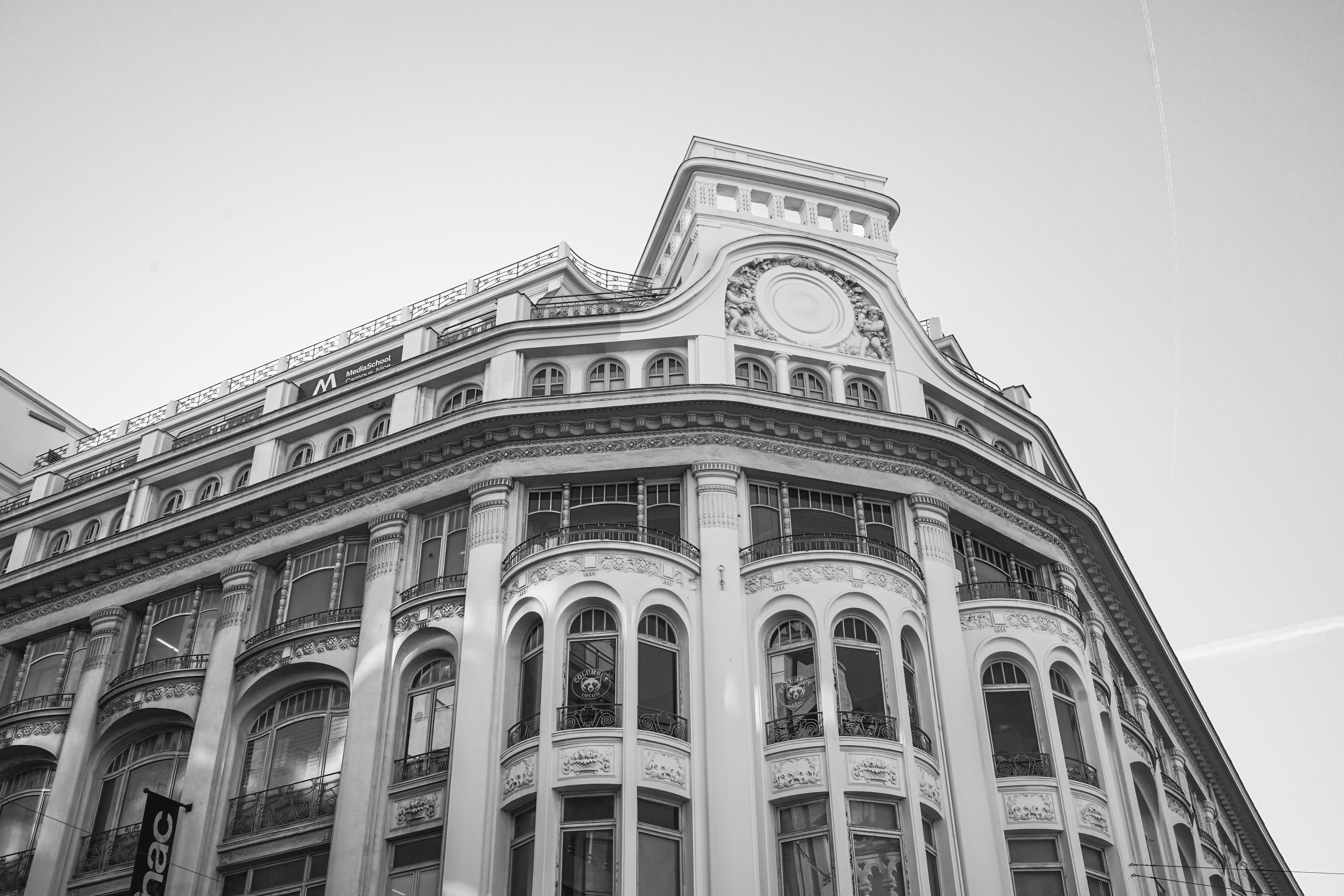 Ornate building facade with arched windows against sky