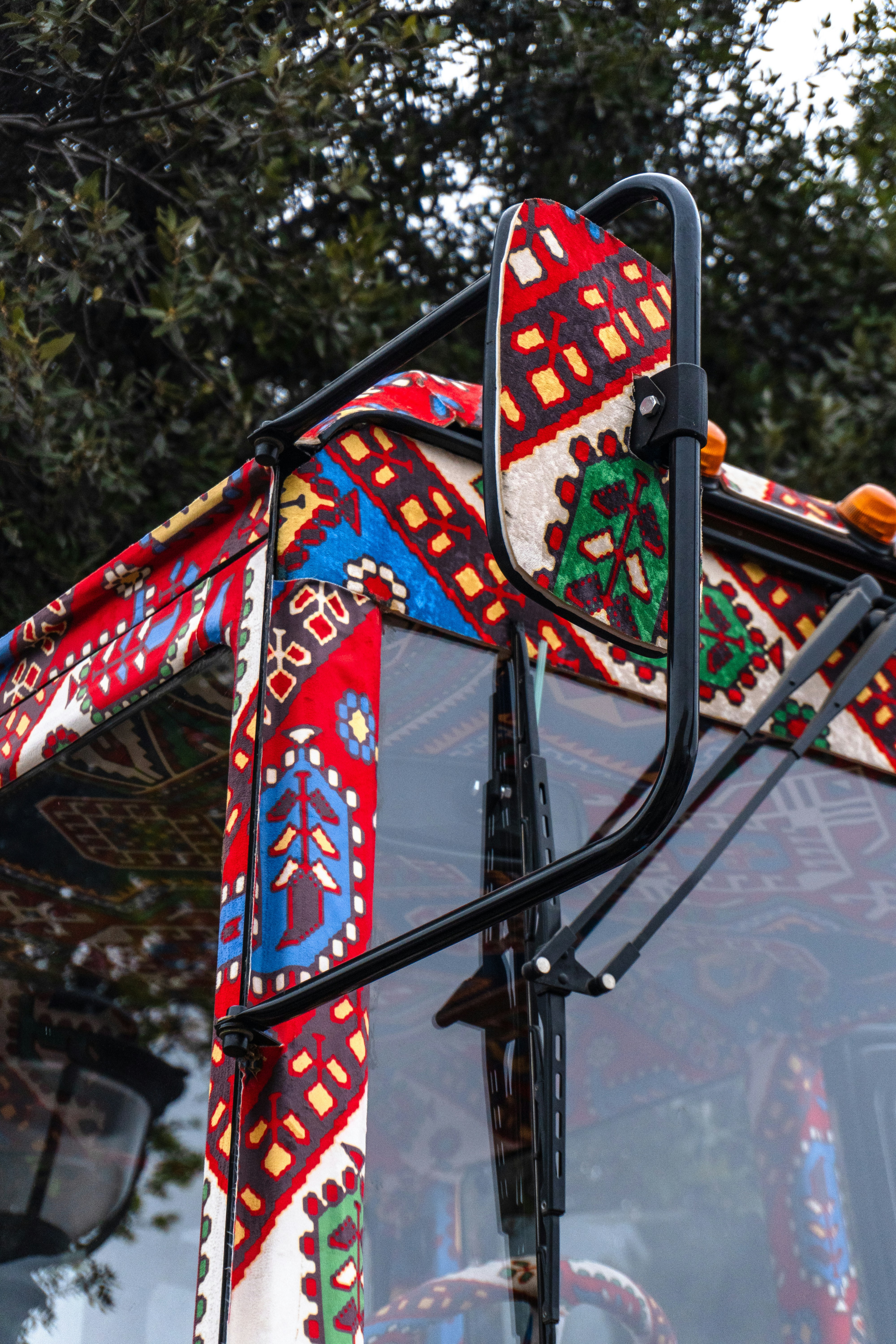 A truck decorated with colorful traditional patterns.