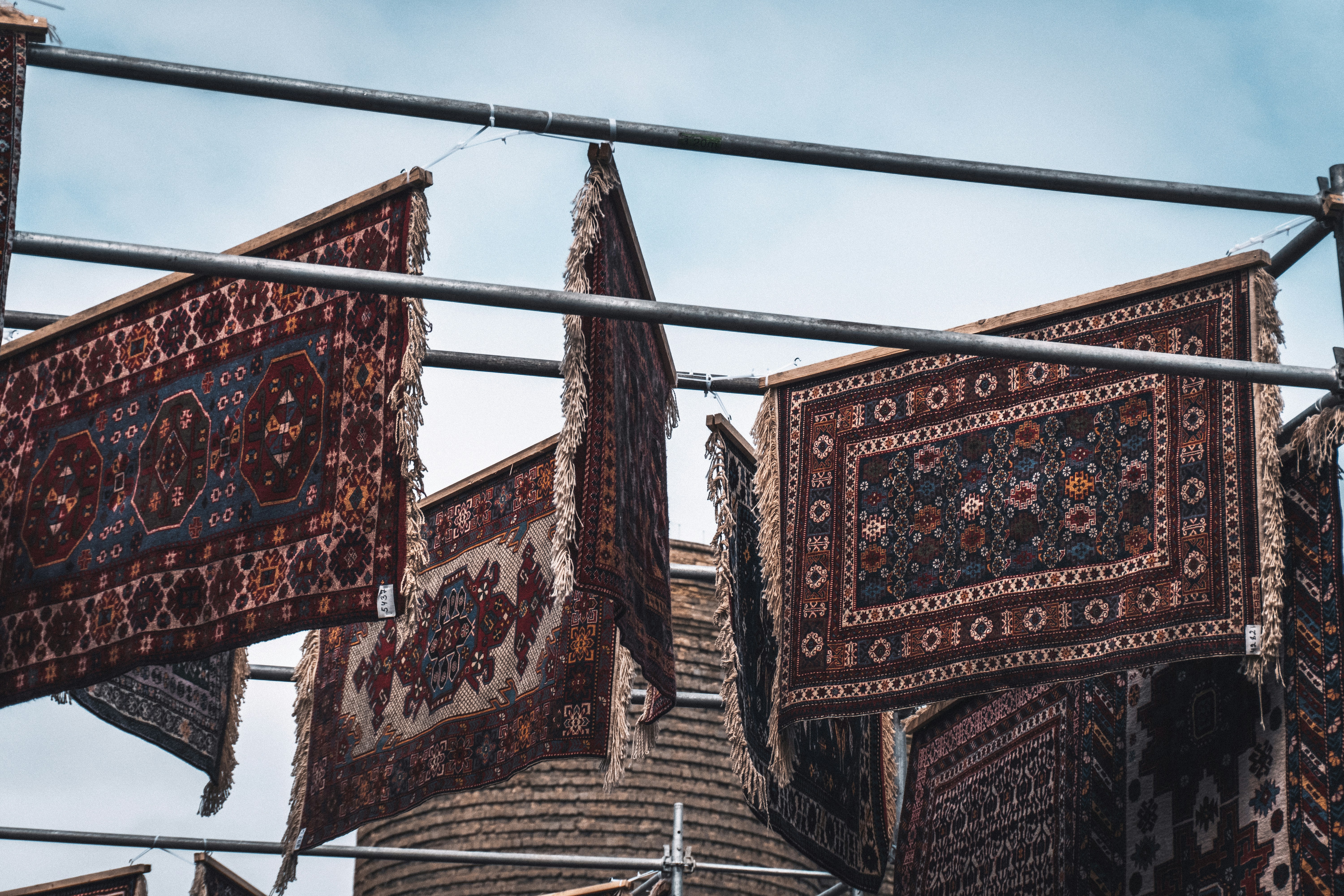 Persian rugs hanging outdoors to dry