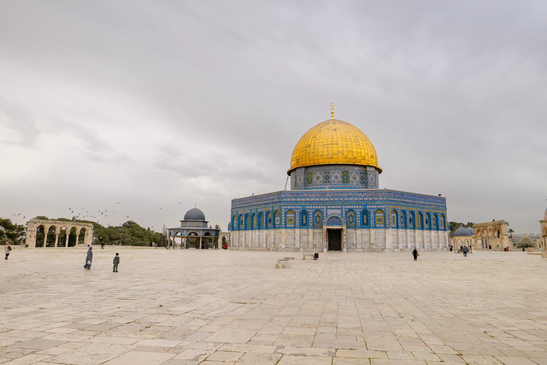 The dome of the rock mosque under a cloudy sky