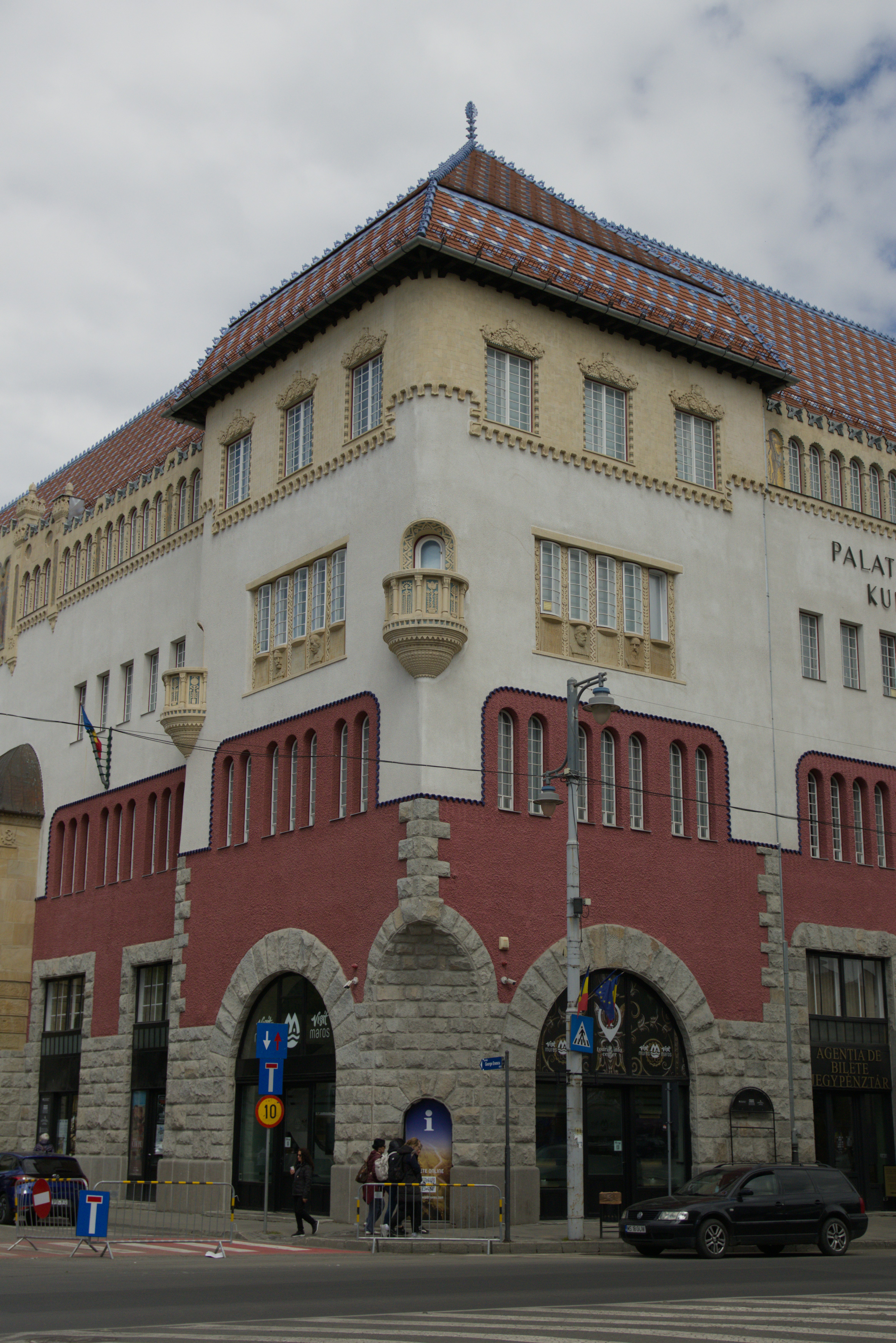 Ornate building with red and white facade and tiled roof