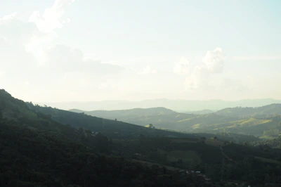 Rolling hills and mountains under a hazy sky