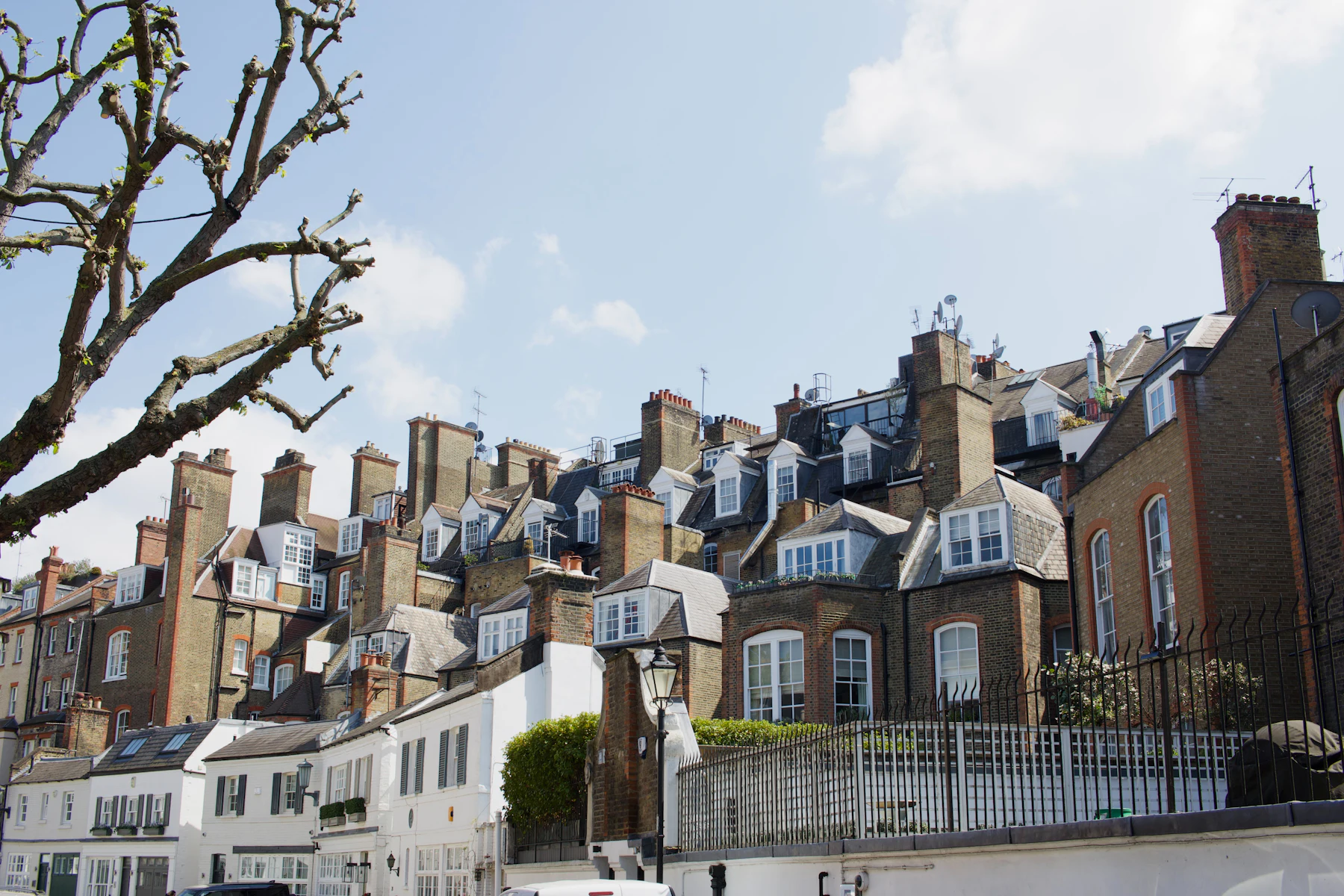 Terraced houses with rows of chimneys against a blue sky
