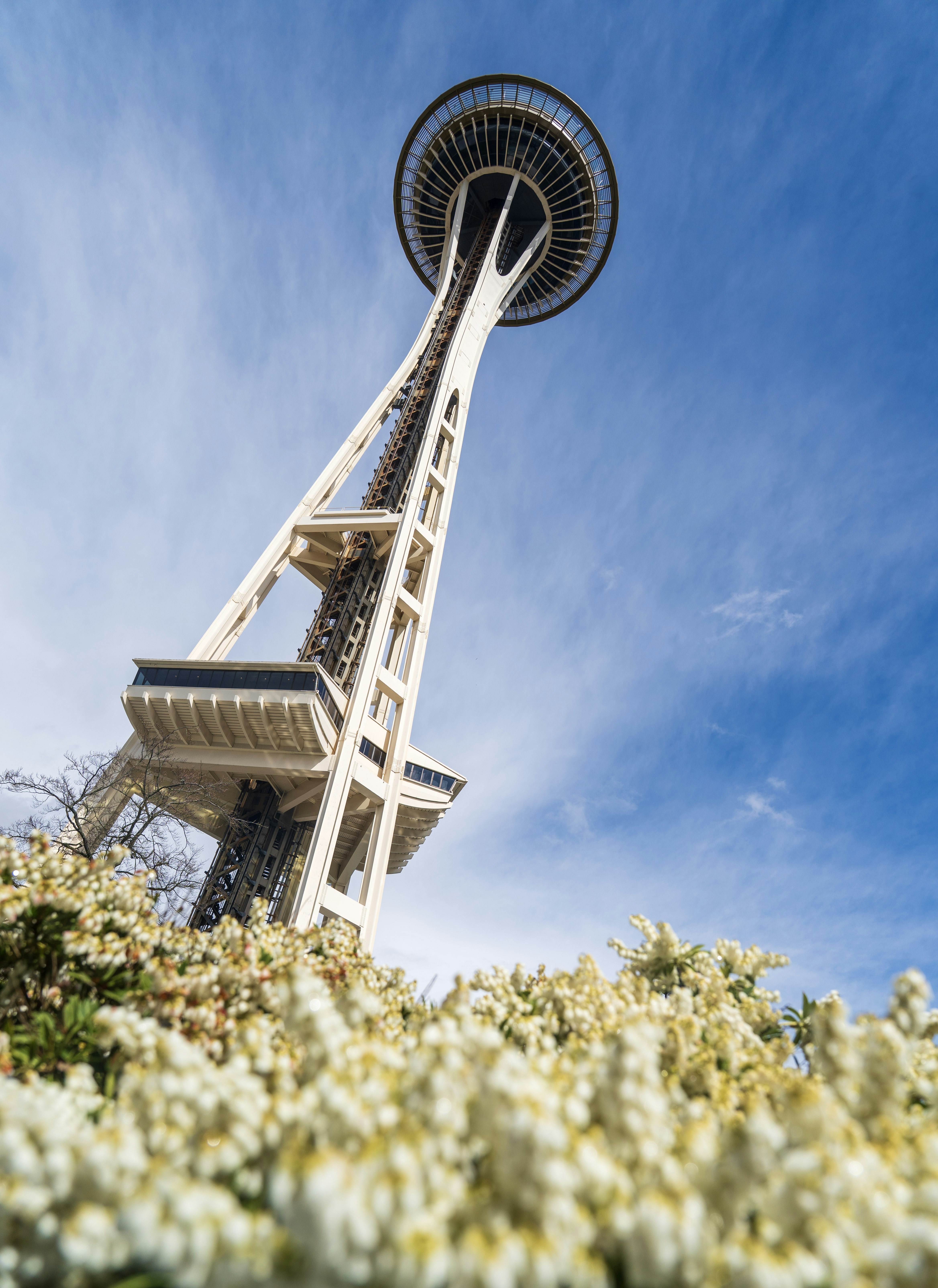 Space needle landmark against a blue sky with clouds