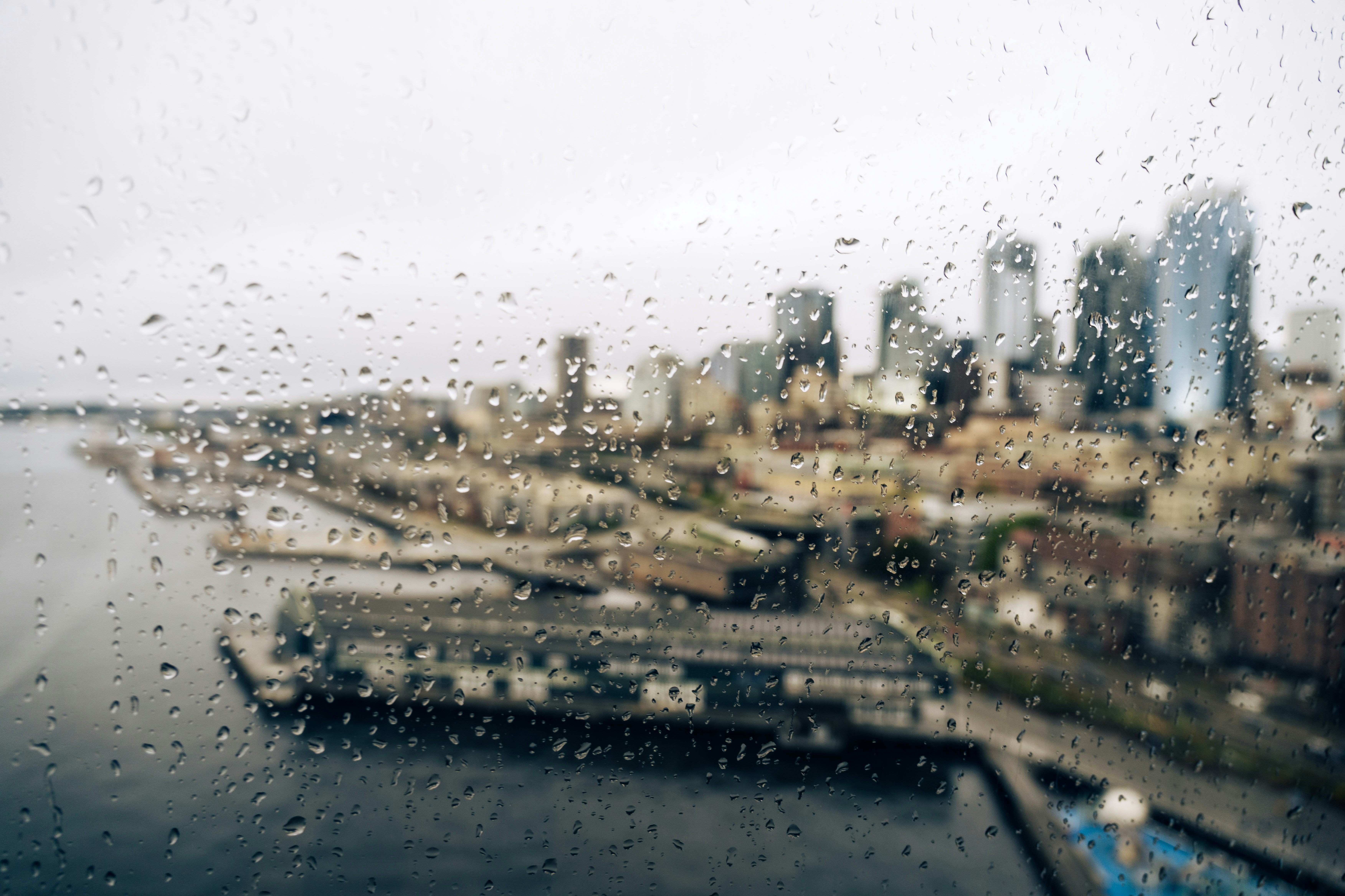 Raindrops on window overlooking city skyline