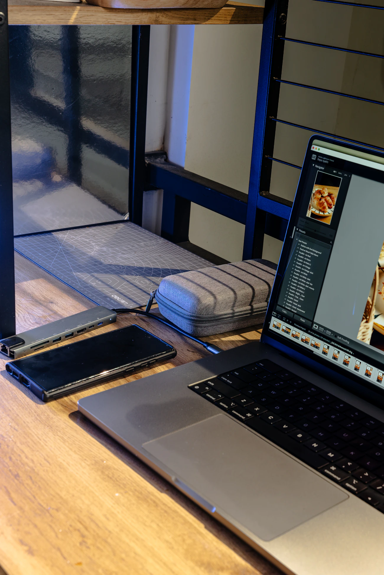 Laptop, smartphone, and connectivity hub arranged on a workspace desk