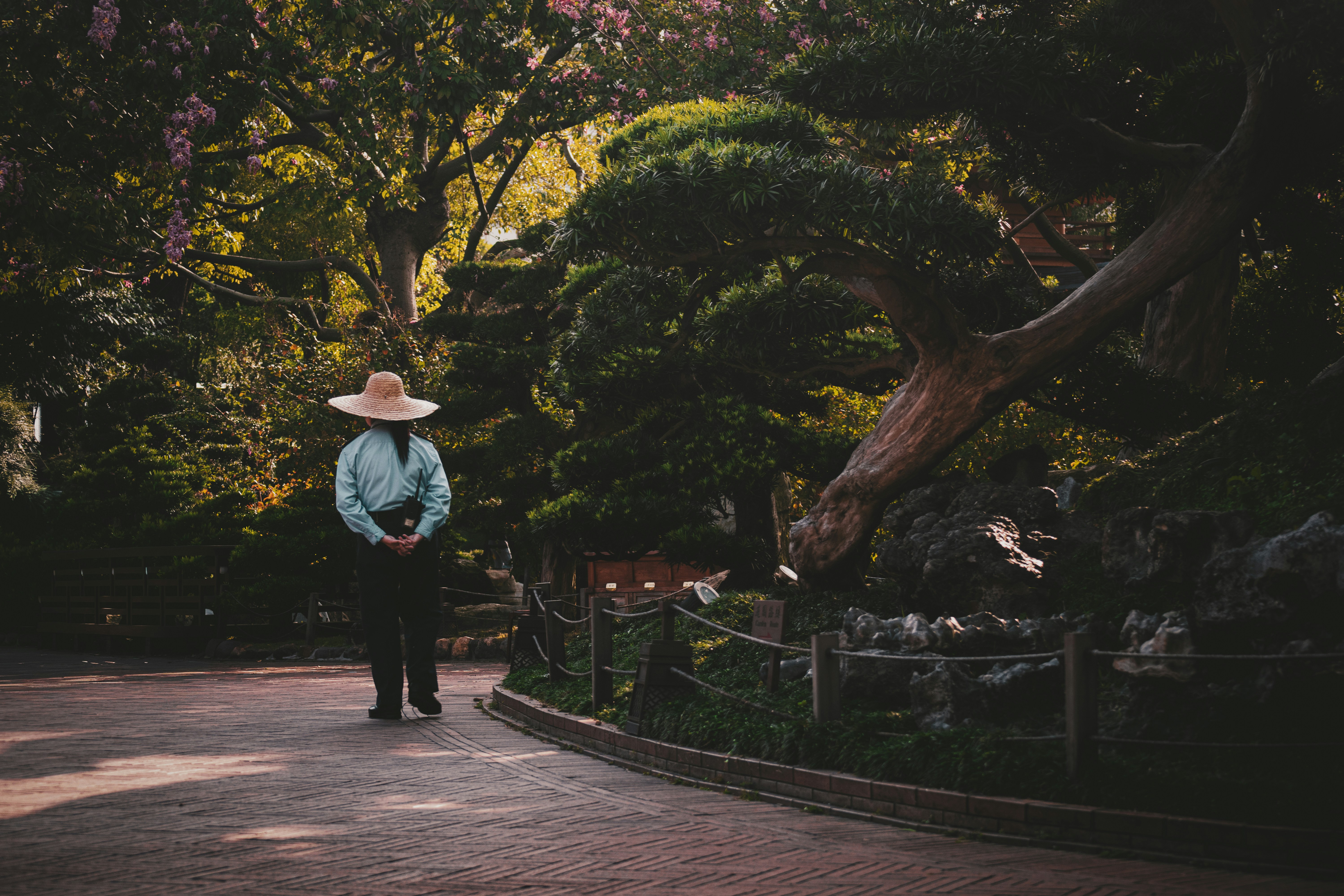 Person practicing deep breathing exercises outdoors in a serene garden