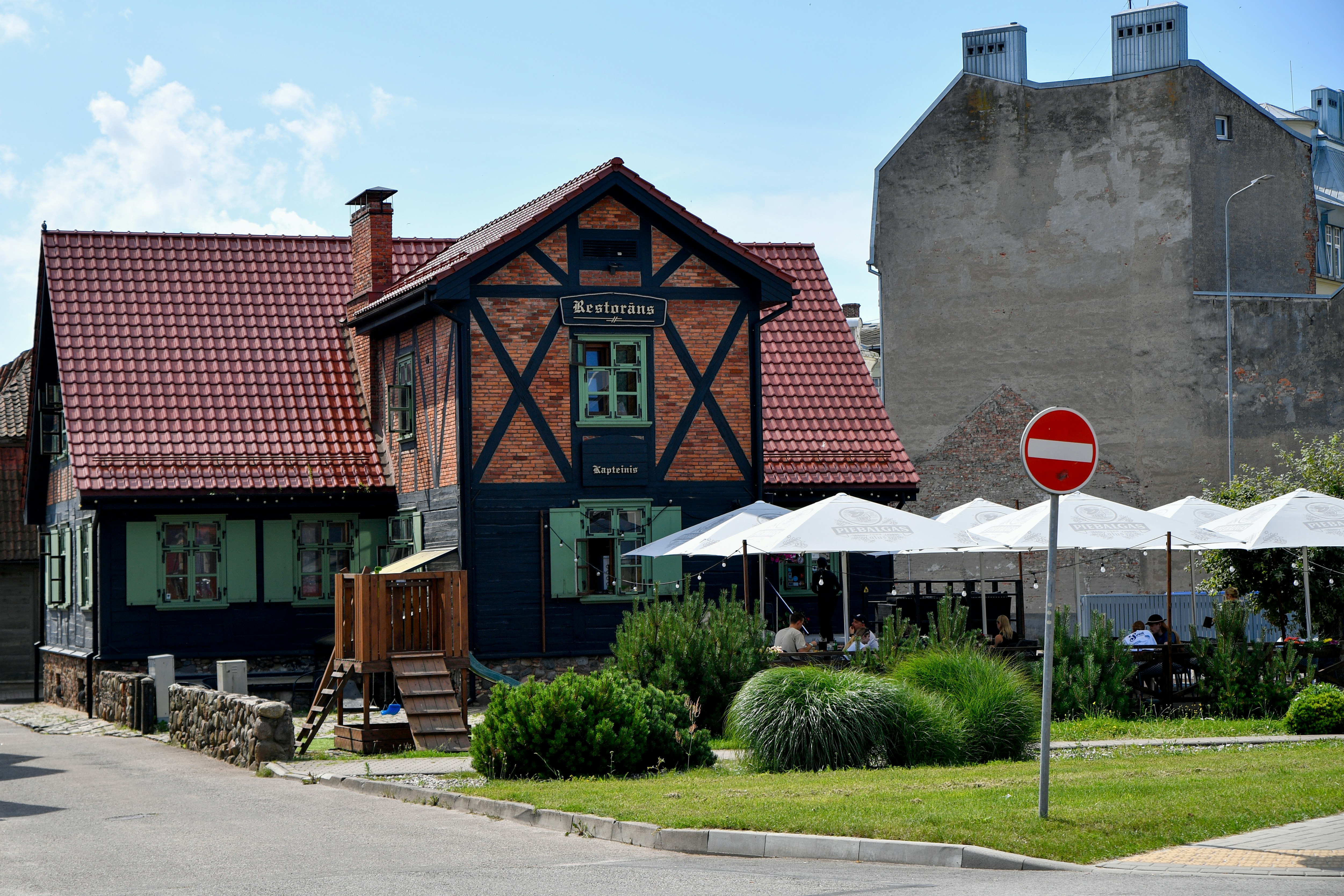 Half-timbered building with outdoor seating and umbrellas