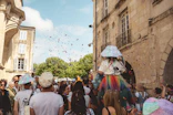 People celebrate with confetti during a street festival.