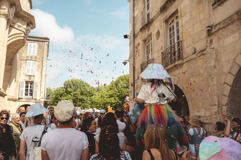 People celebrate with confetti during a street festival.