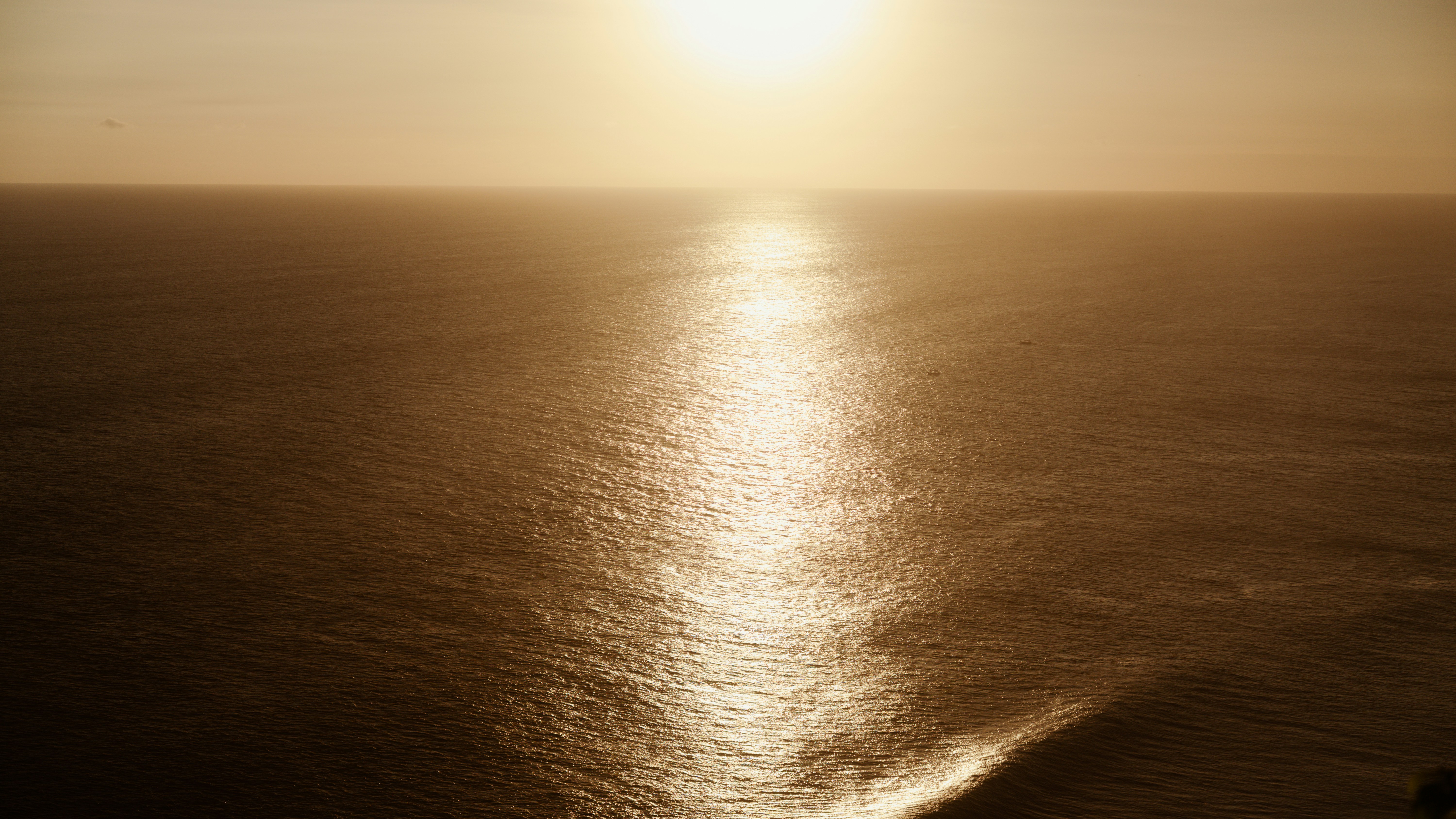 Golden sunbeam reflecting on the ocean surface