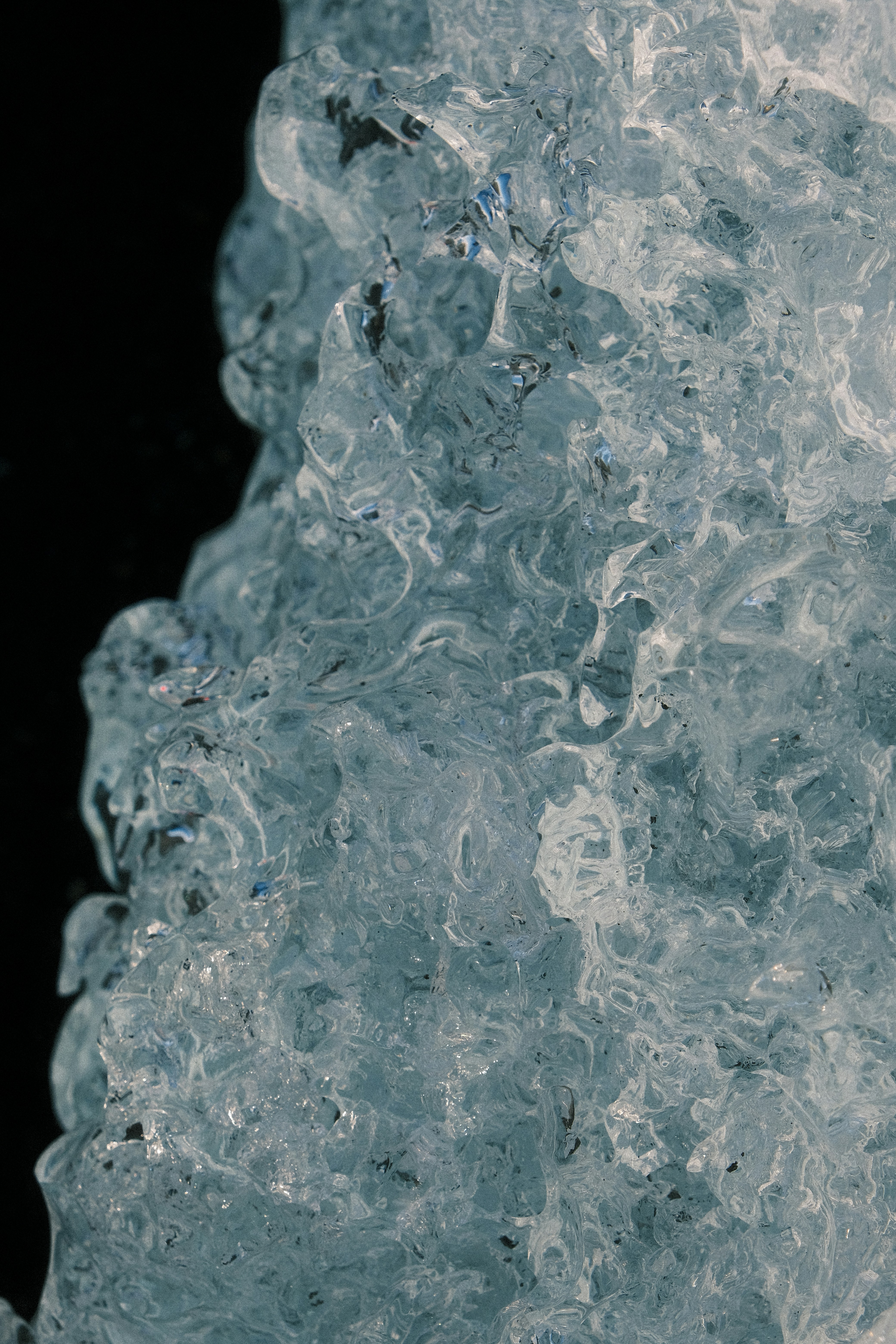 Close-up of textured ice with dark background