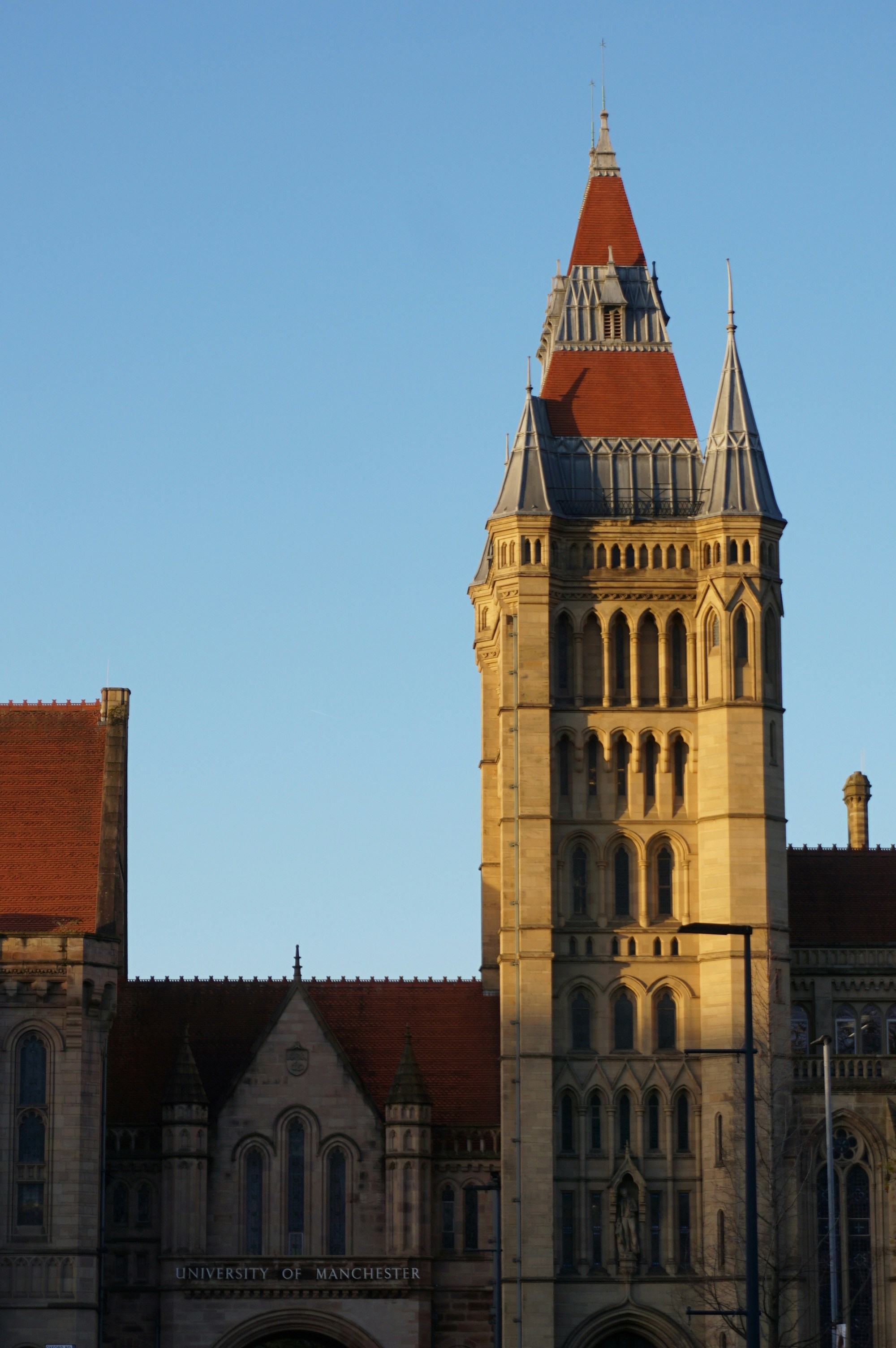 Historic building with ornate tower against blue sky