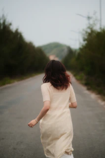Woman in a light dress running mental health