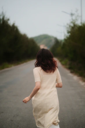 Woman in a light dress running mental health