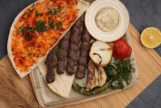 Grilled meat skewers with flatbread and grilled vegetables
