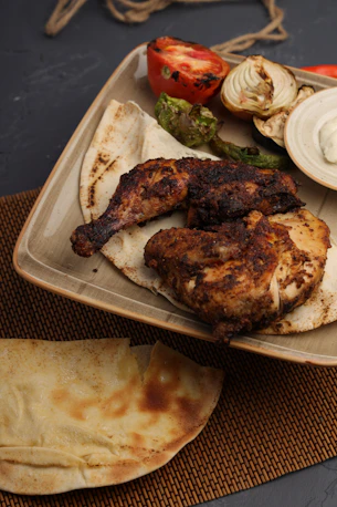 Grilled chicken with vegetables and flatbread on a plate