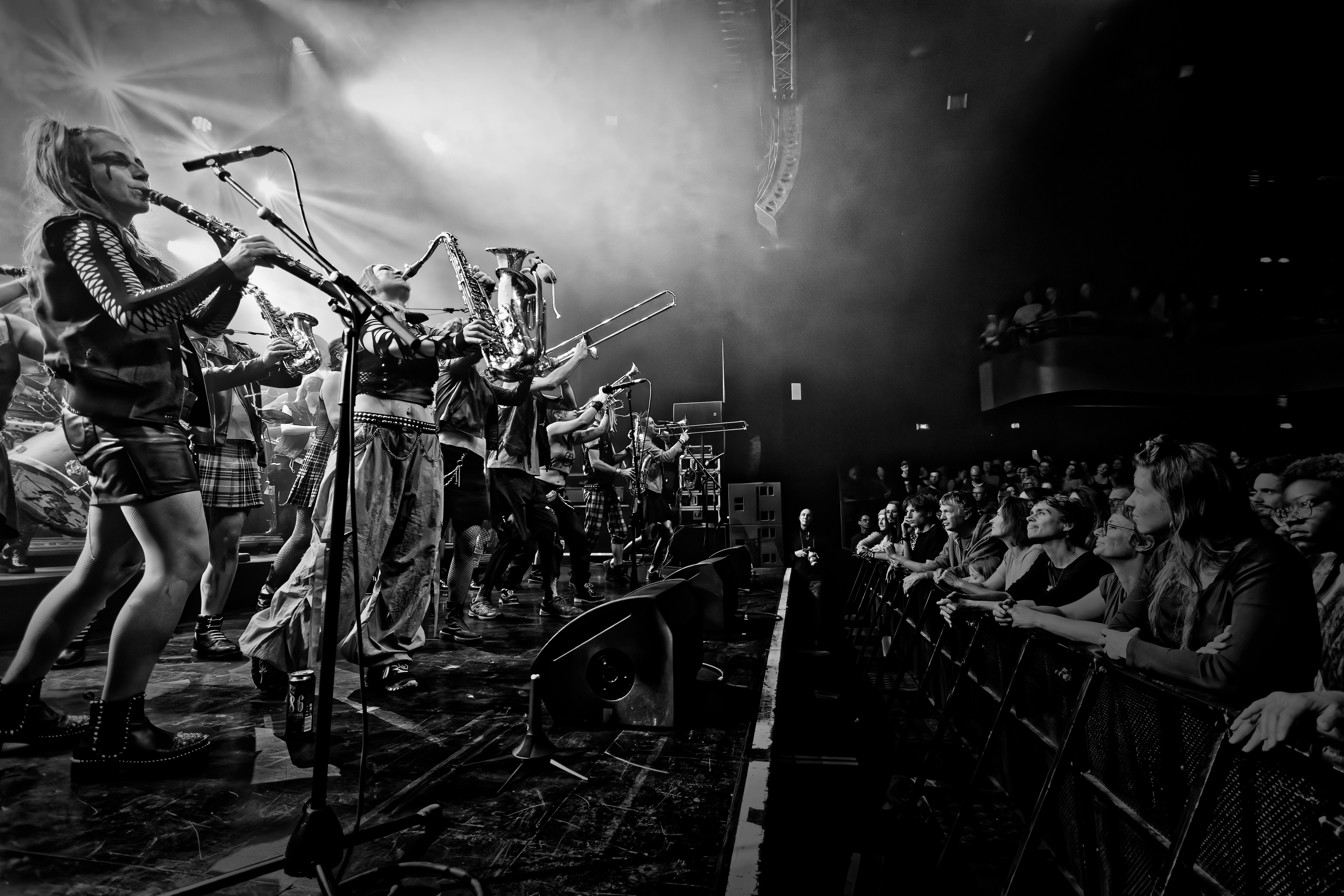 Band performing live on stage for an enthusiastic audience.