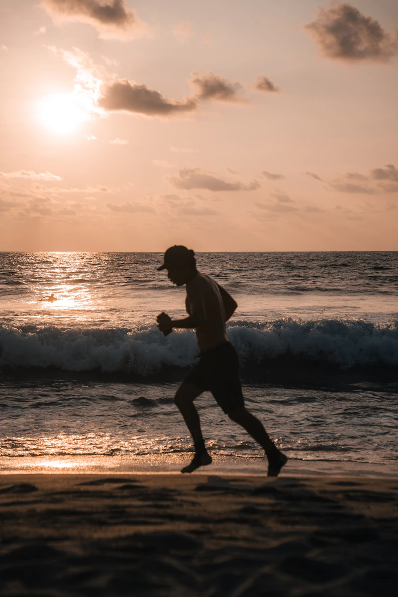 Man running outdoors at sunset