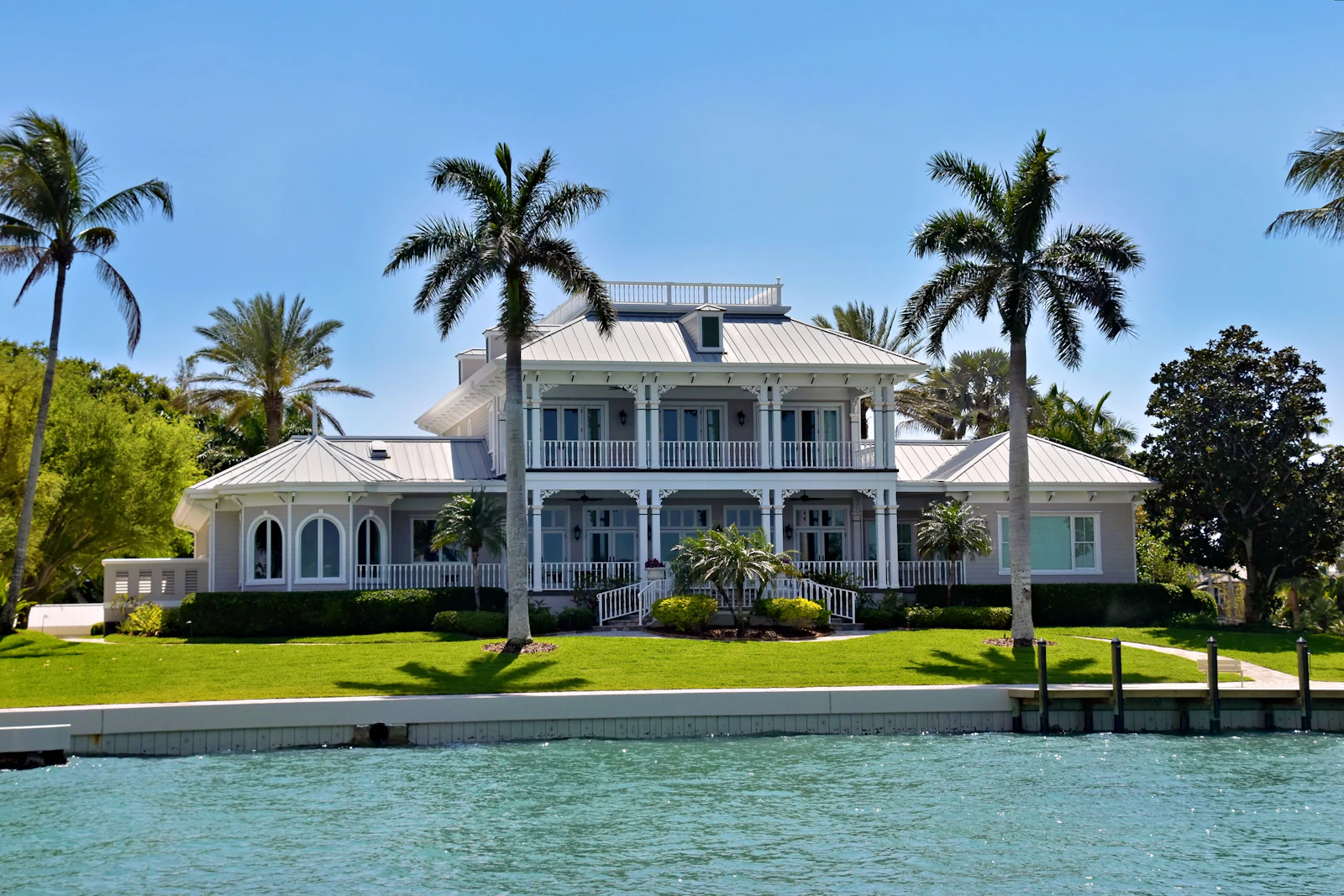 Waterfront luxury home with palm trees, South Florida