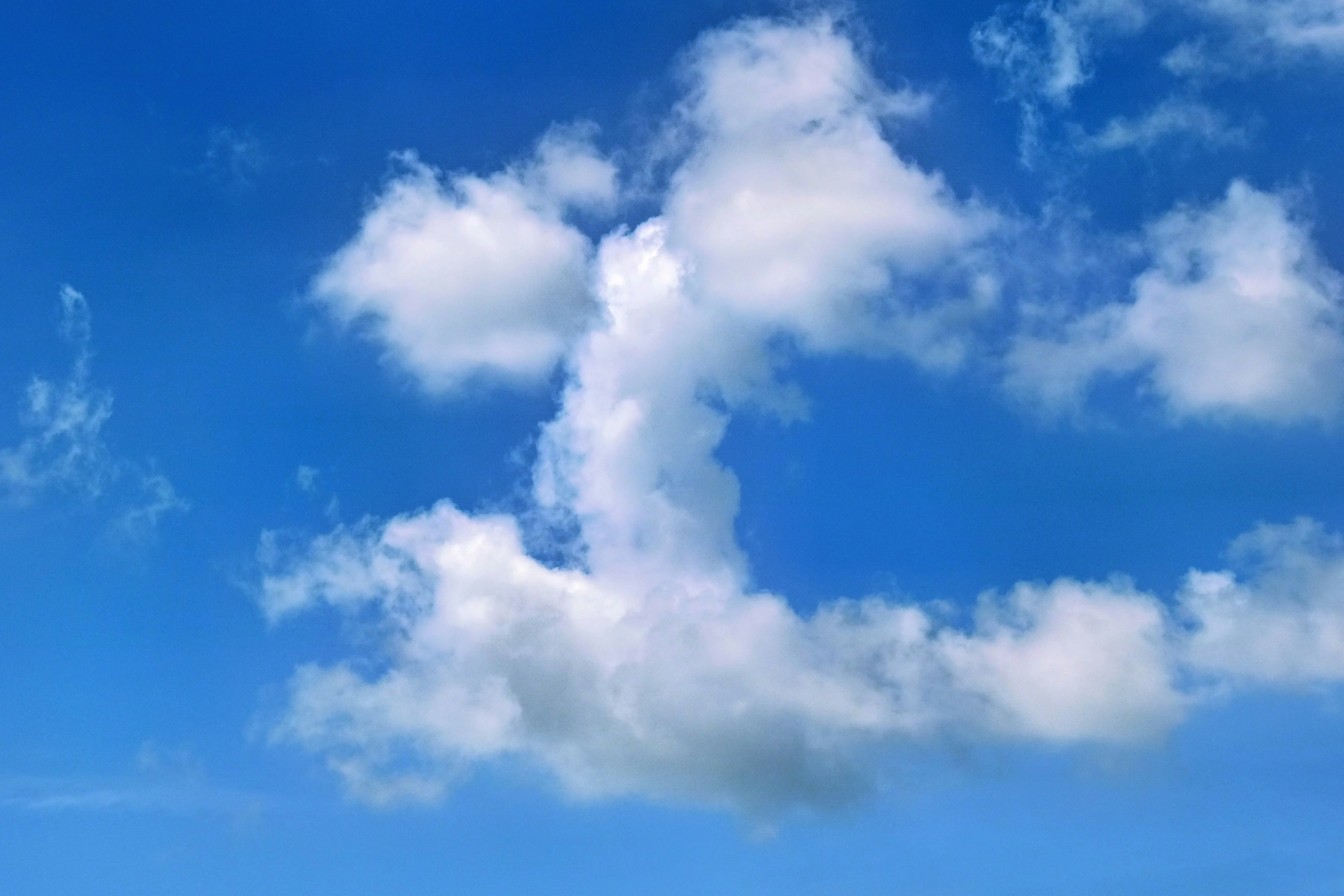 Fluffy white clouds against a bright blue sky