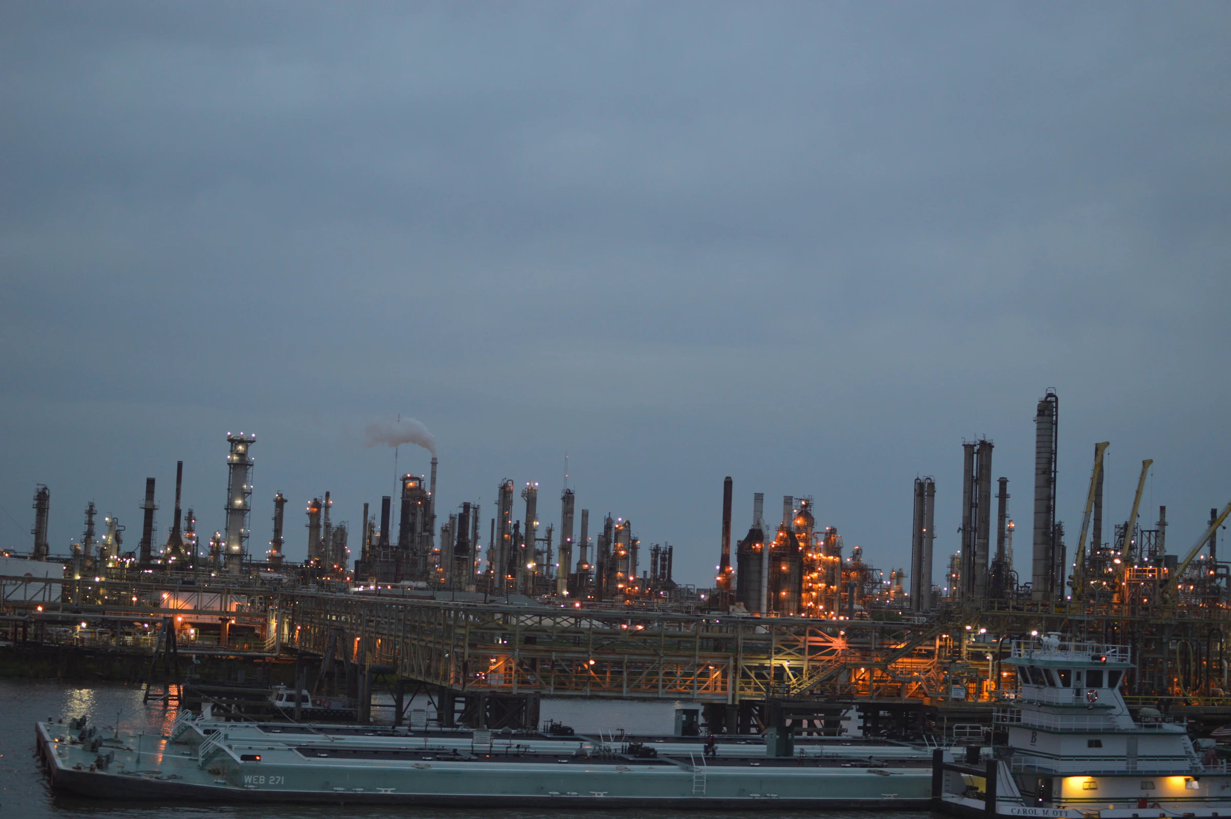 Industrial refinery and maritime infrastructure at dusk