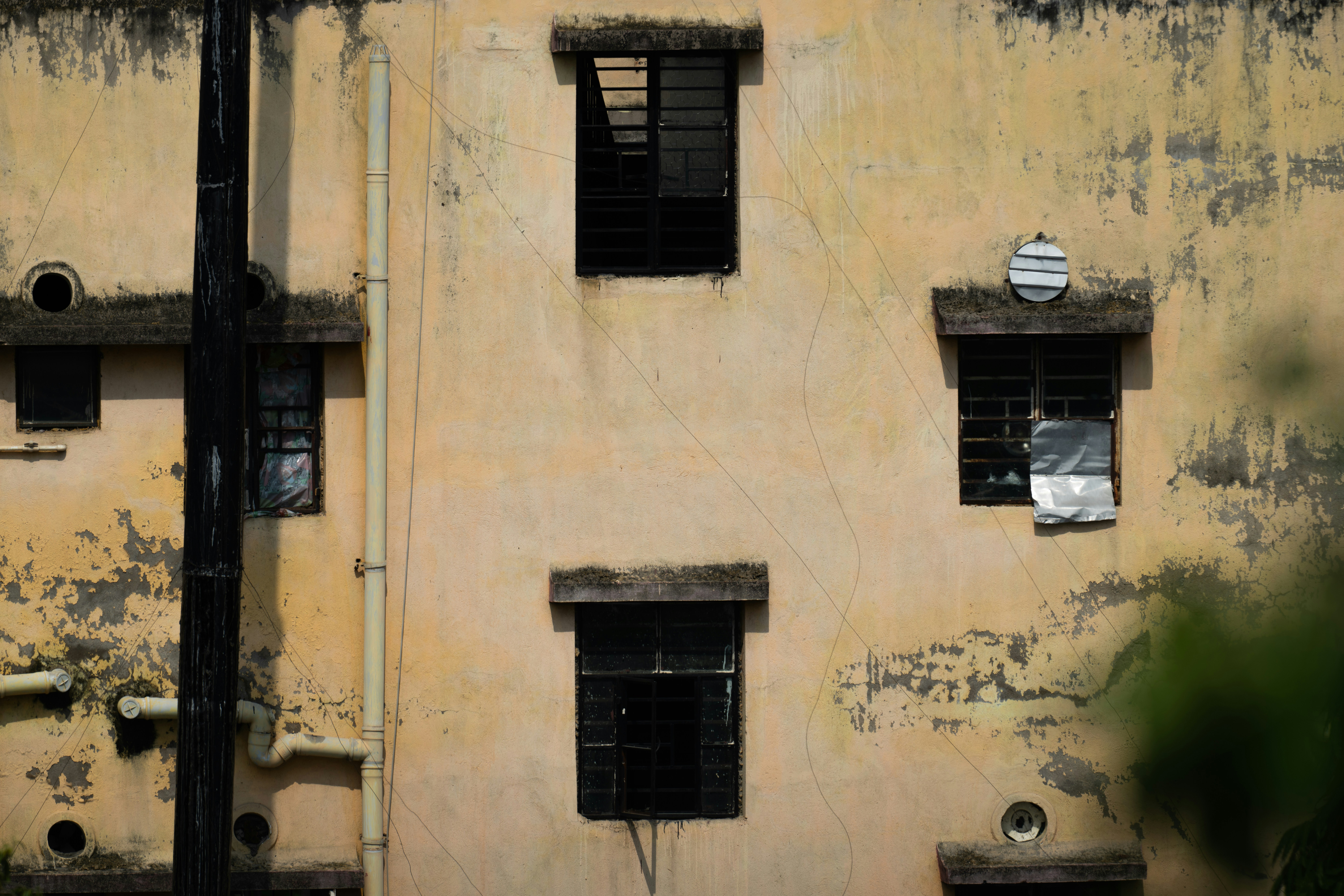 Old building facade with multiple windows and peeling paint
