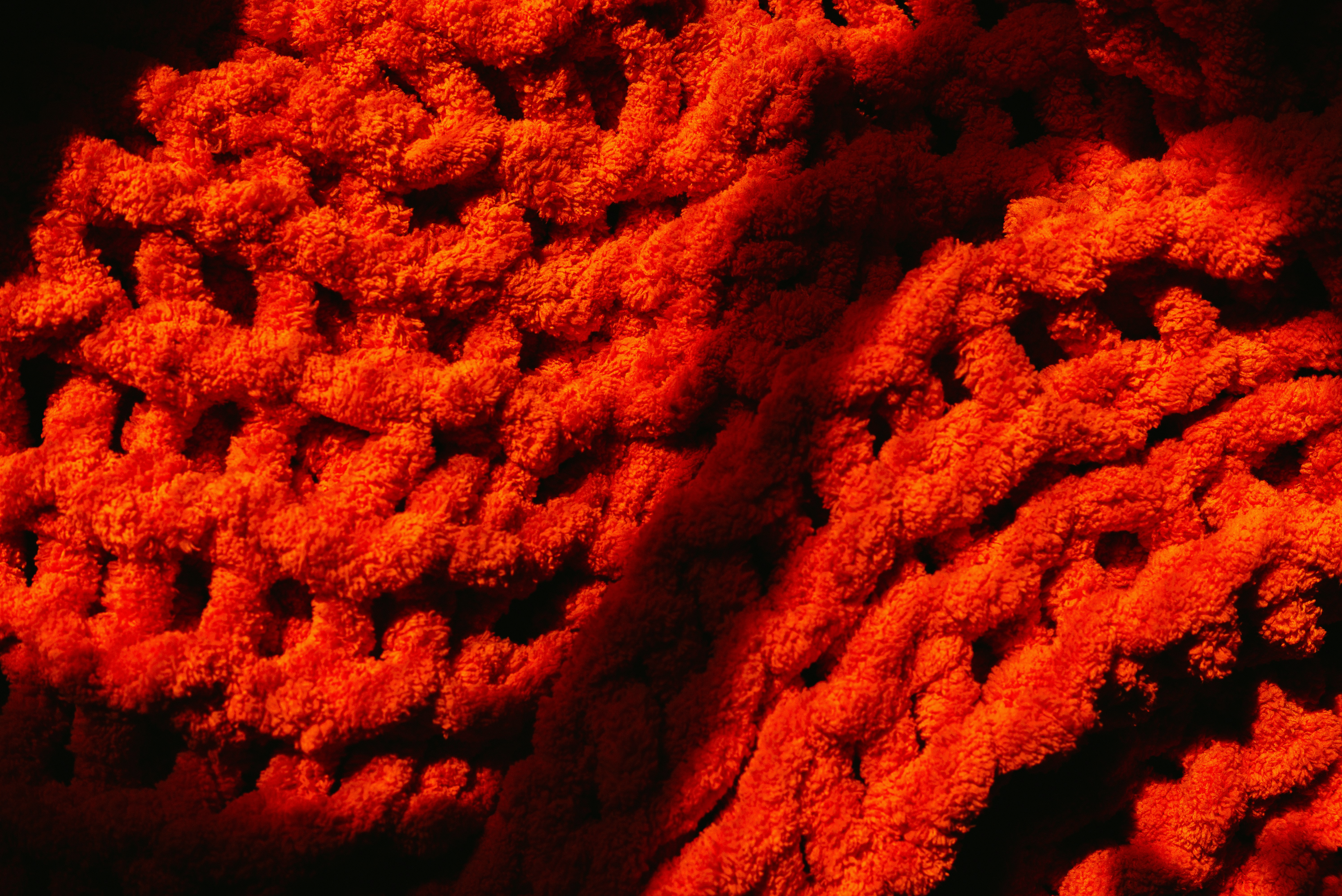 Close-up of a textured orange knitted fabric