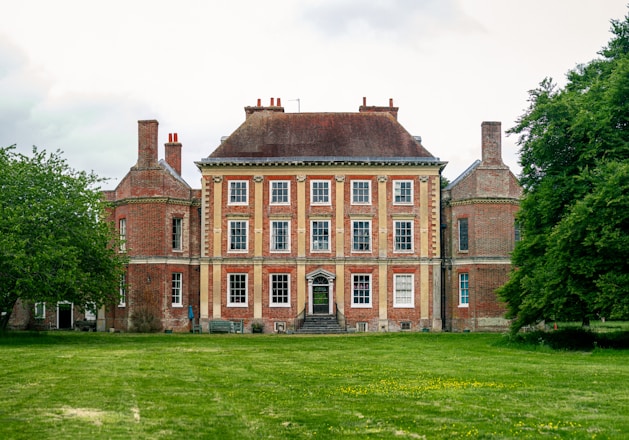 English Georgian manor house with red-brick façade and lawn