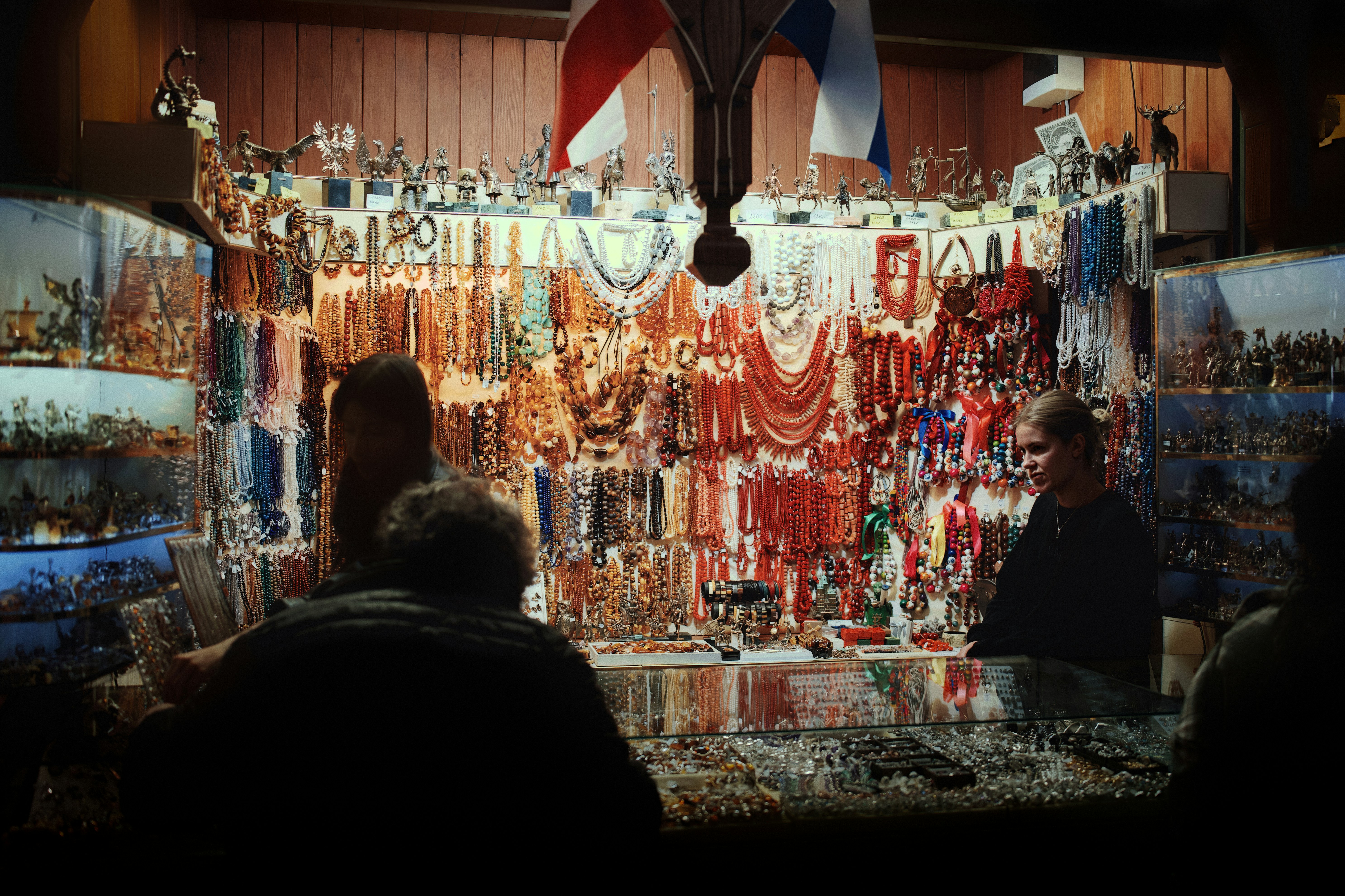 A crowded stall selling jewelry and trinkets at night.
