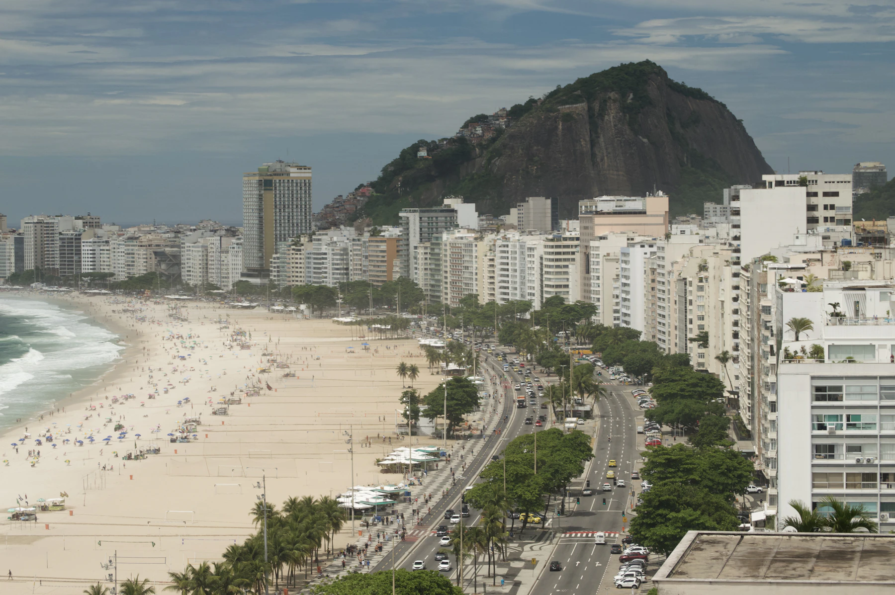 Copacabana Beach, its curved waterfront and Rio de Janeiro's mountains seen from above
