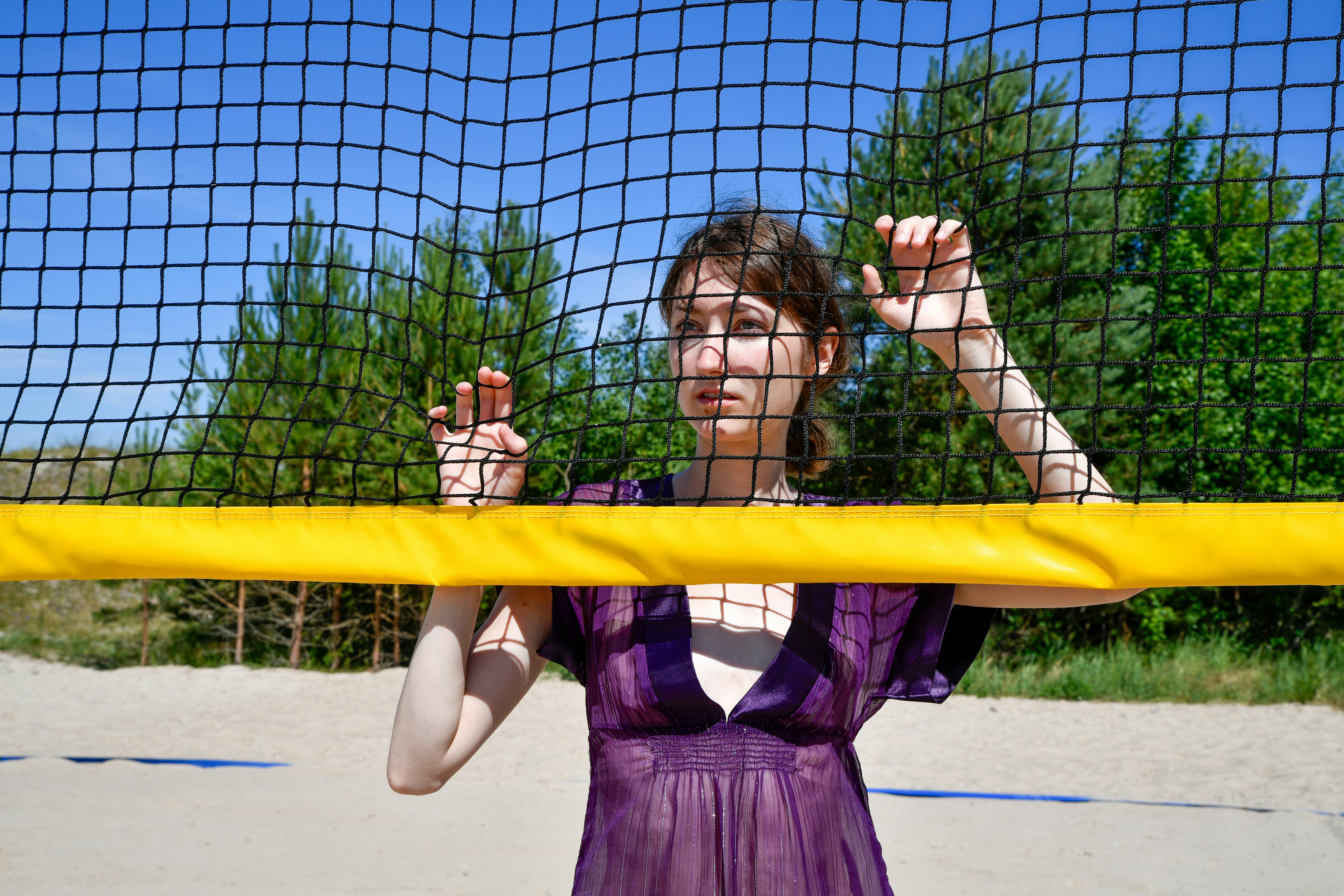 Woman in purple dress behind a volleyball net - Free Photo on Unsplash
