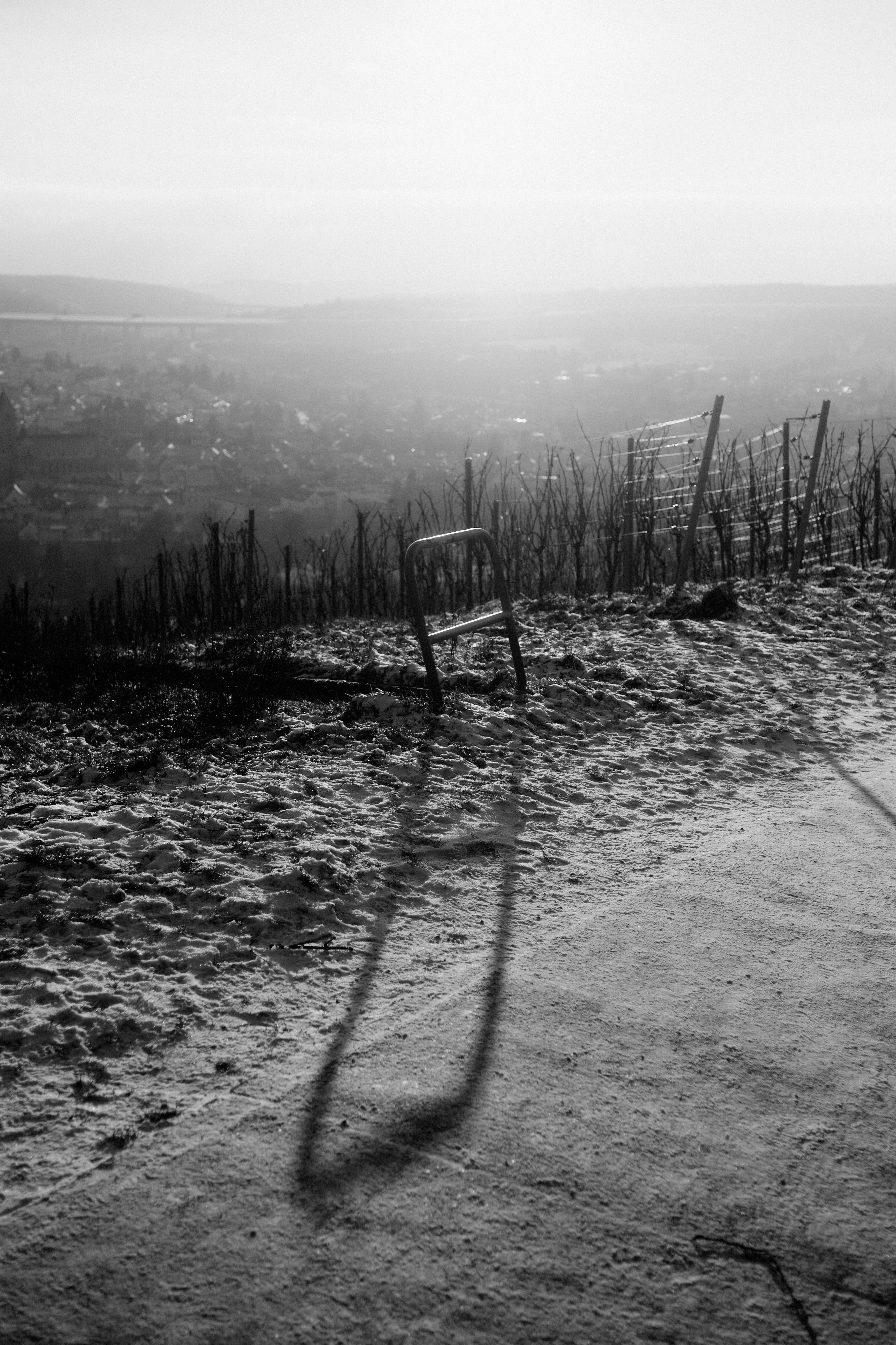Lone chair casts long shadow on frosty hillside