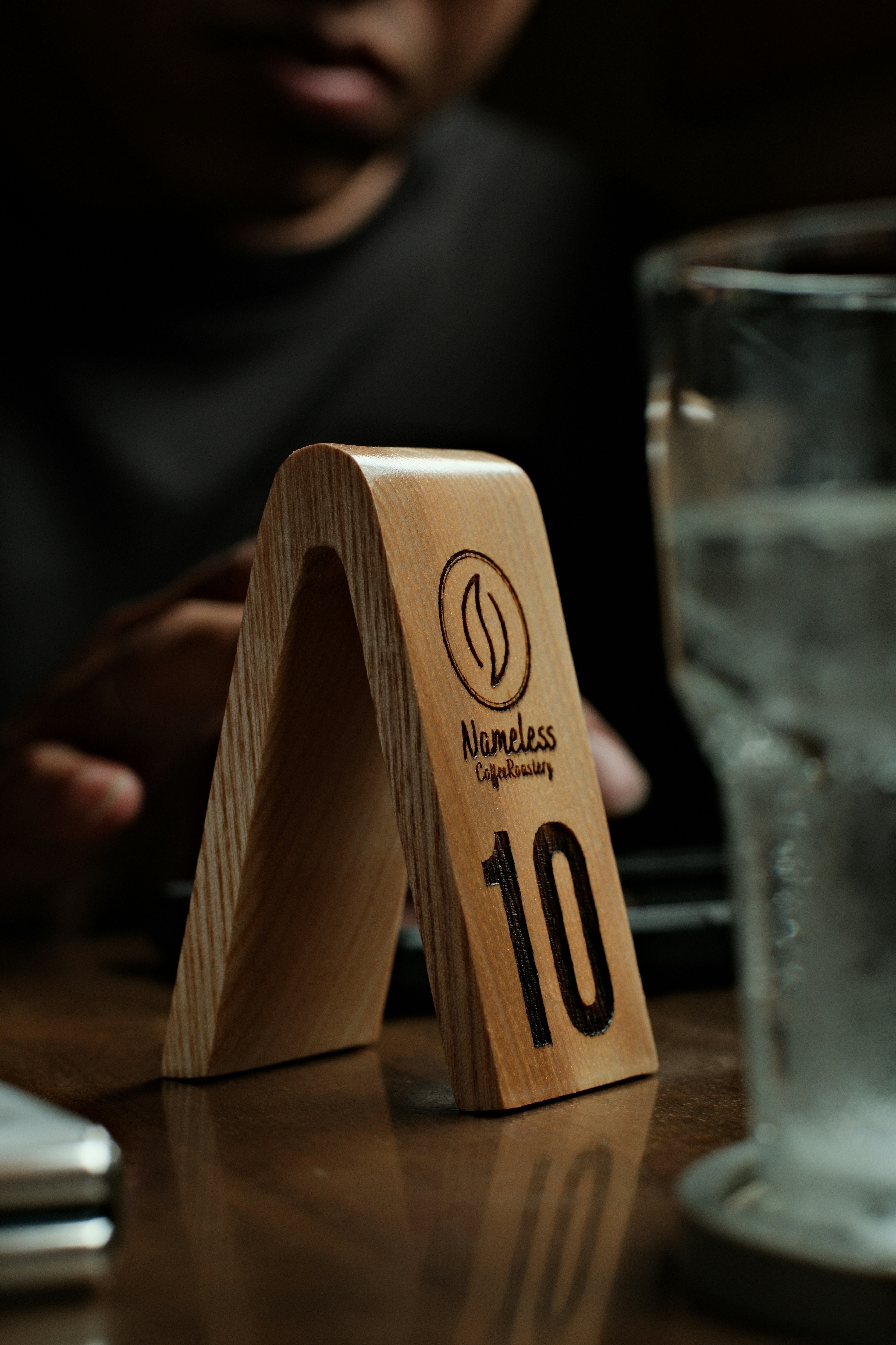 Wooden table number 10 with a logo